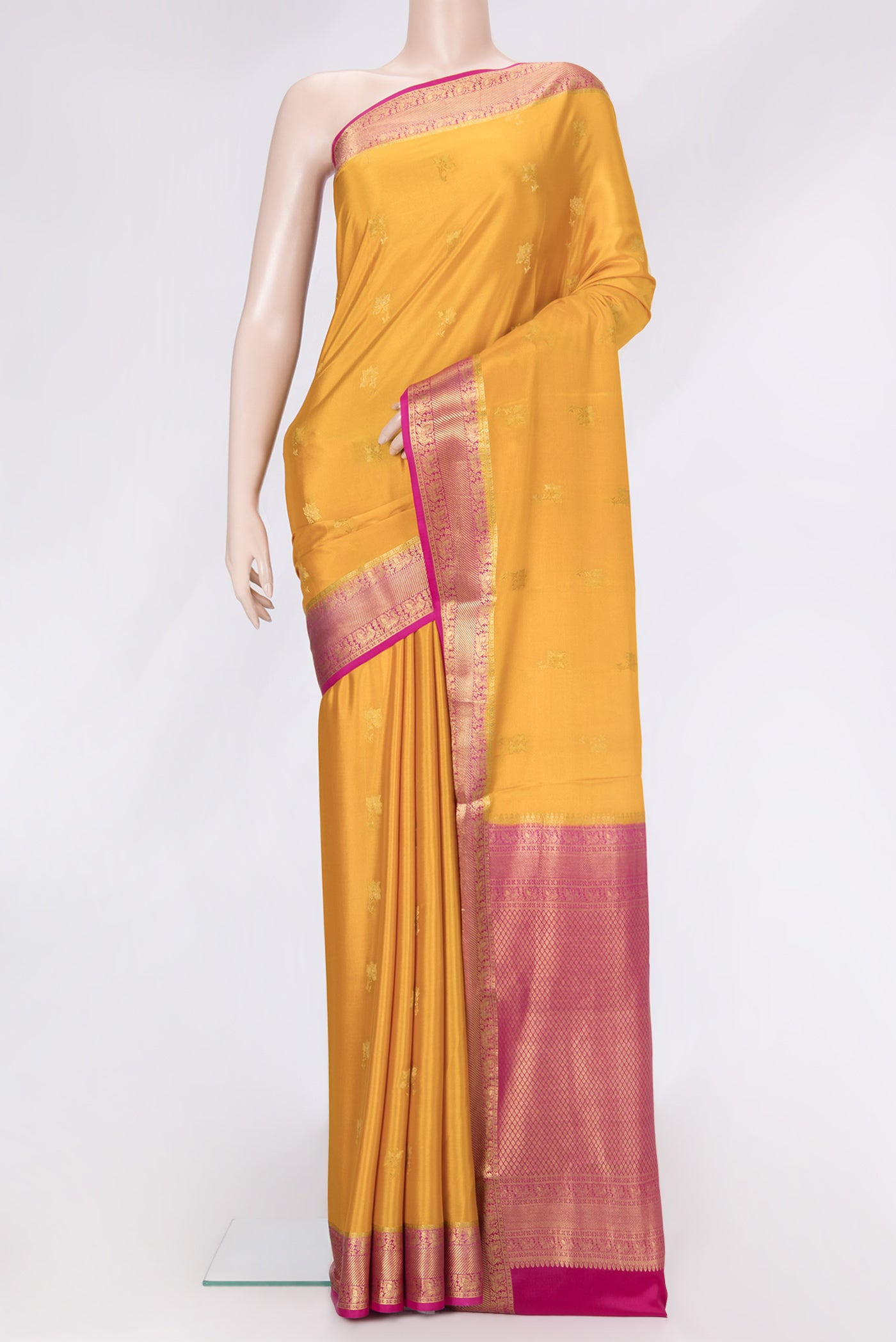 Mustard Dual Tone Mysore Silk Saree with Zari Butta on the body and Zari Border.  displayed on a mannequin