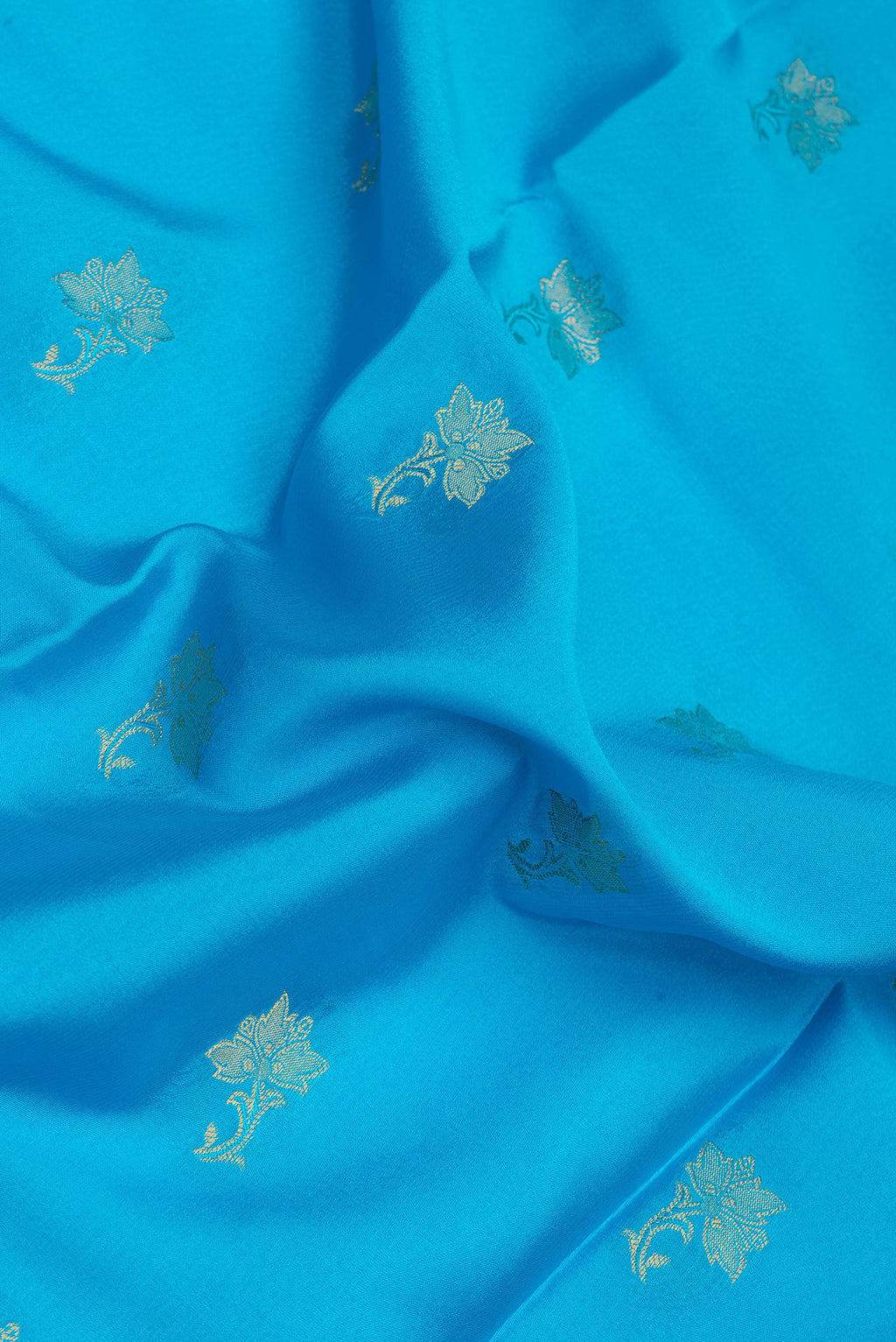 Close up of Sky Blue Dual Tone Mysore Silk Saree with Zari Butta on the body and Zari Border.  displaying folds