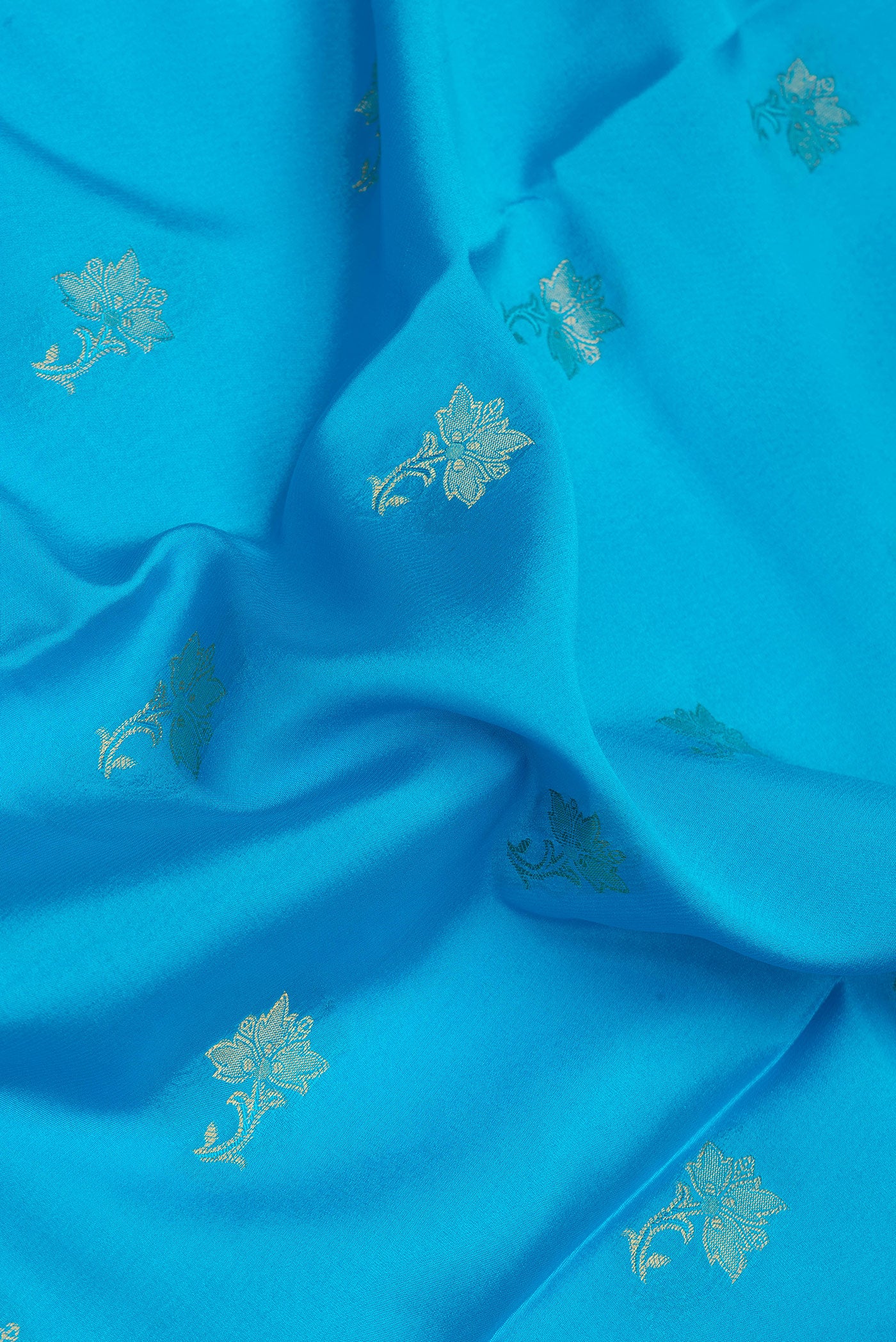 Close up of Sky Blue Dual Tone Mysore Silk Saree with Zari Butta on the body and Zari Border.  displaying folds