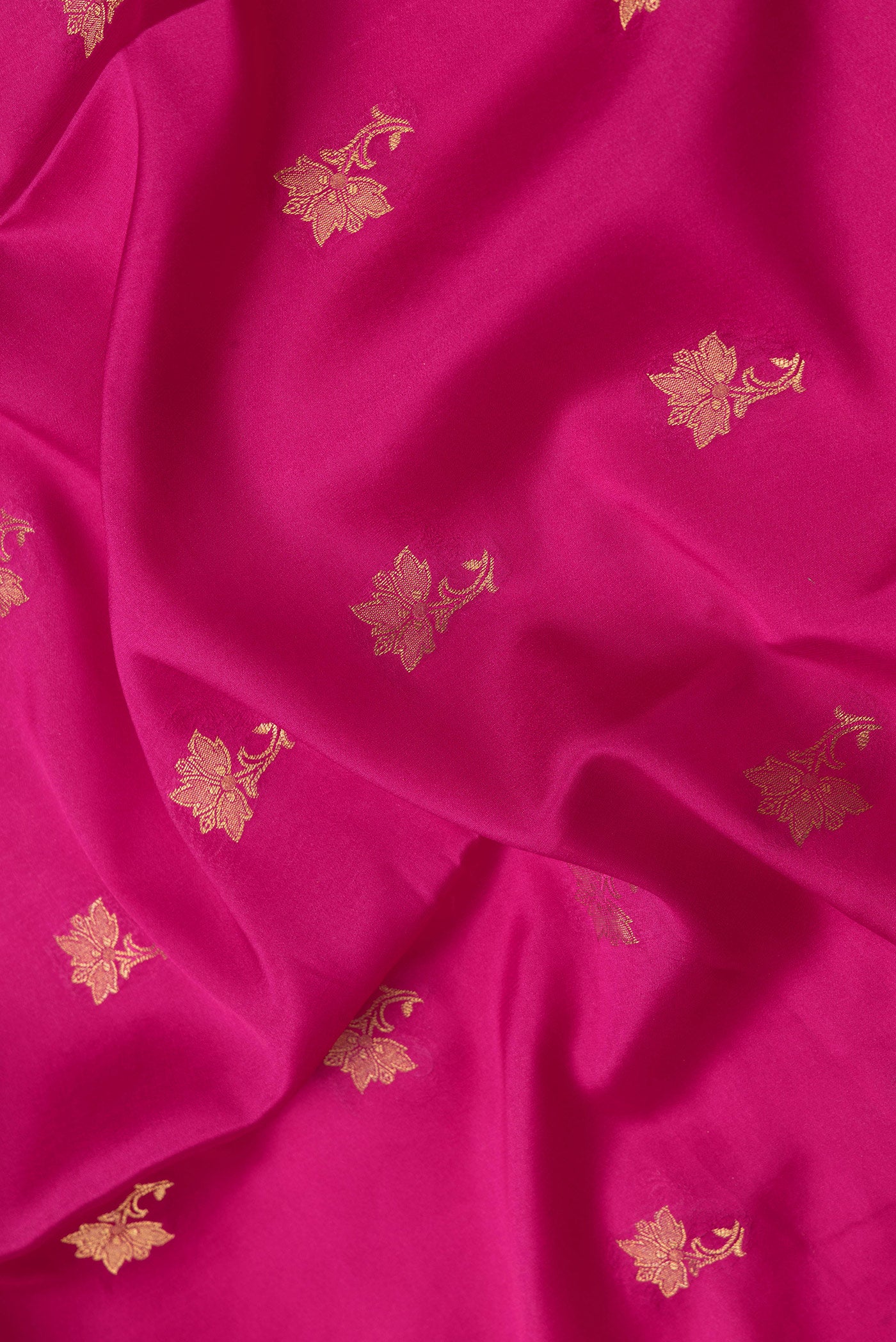 Close up of Magenta Dual Tone Mysore Silk Saree with Zari Butta on the body and Zari Border.  displaying folds