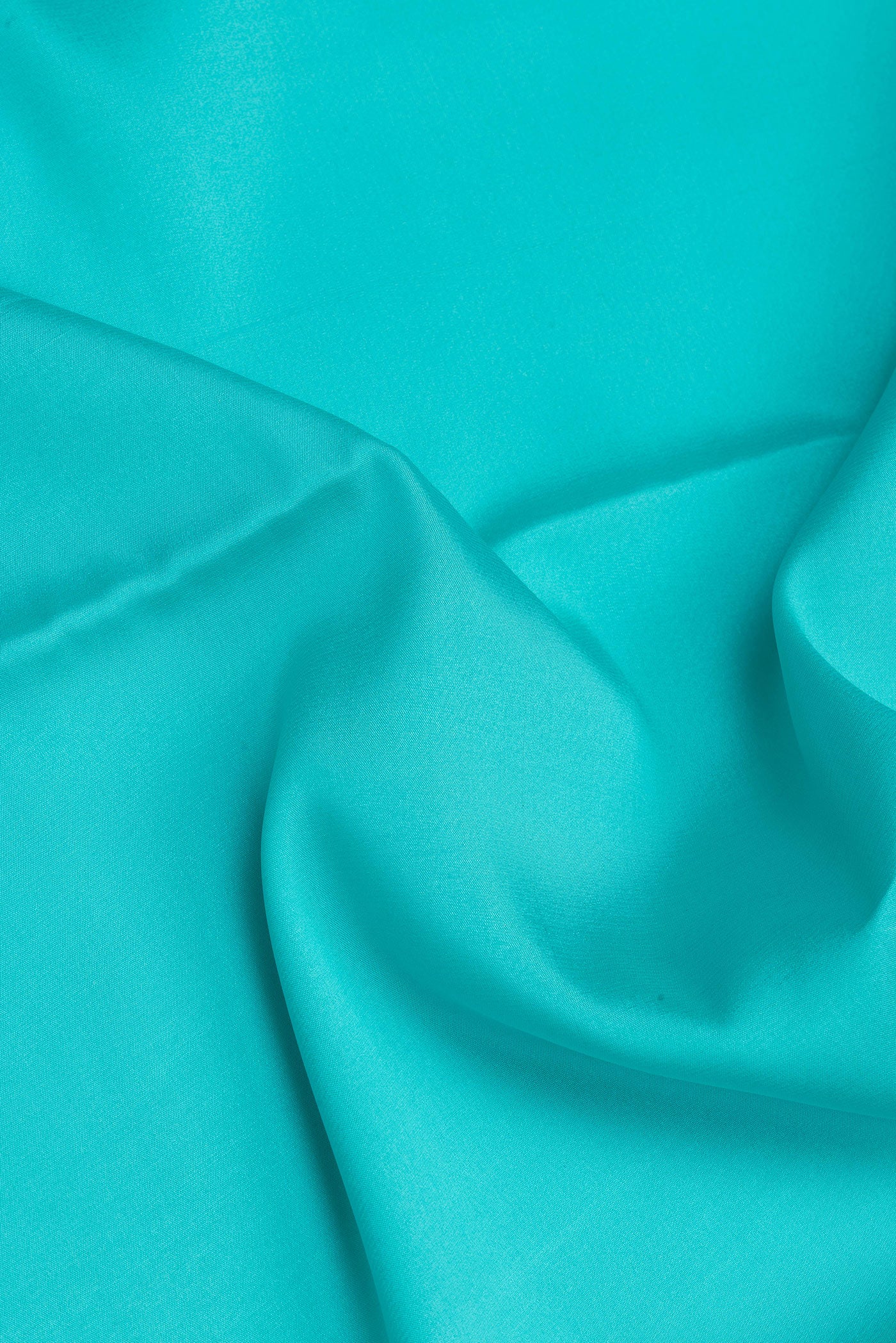 Close up of Sky Blue Mysore Silk Saree with Plain Body and Zari Border.  displaying folds