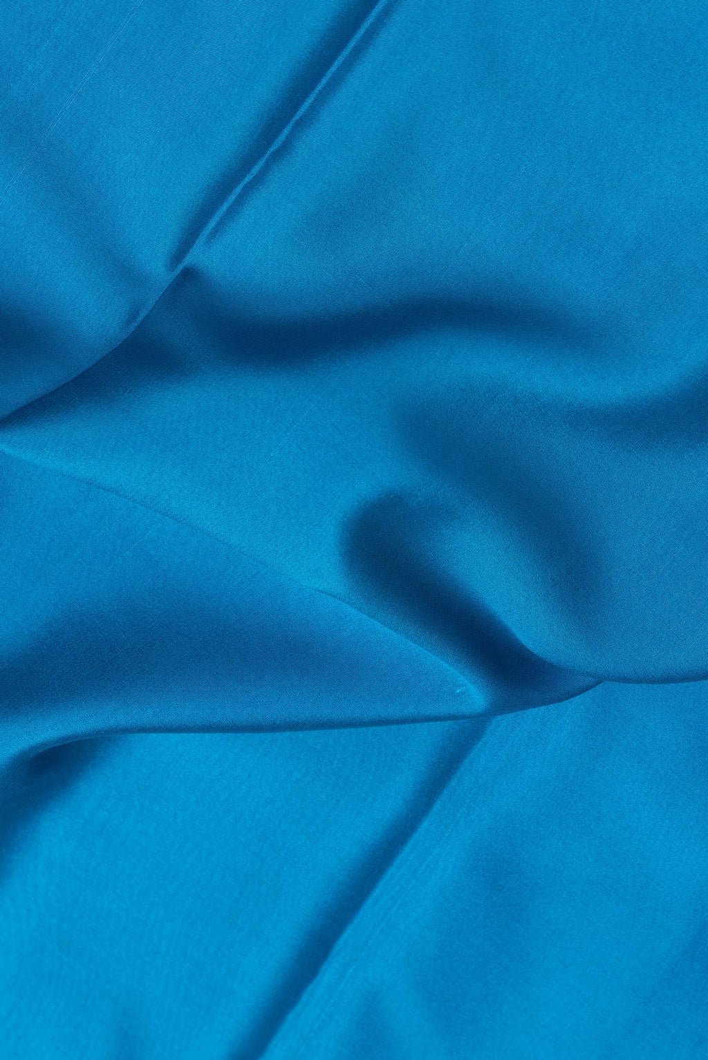Close up of Sky Blue Dual Tone Mysore Silk Saree with Plain Body and Zari Border.  displaying folds