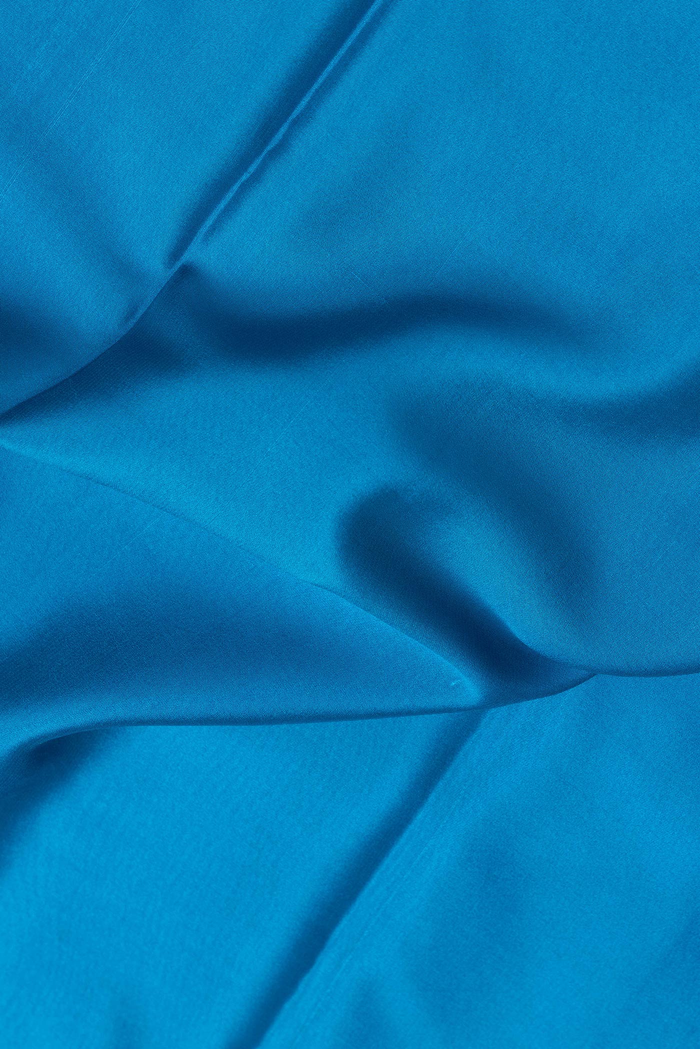 Close up of Sky Blue Dual Tone Mysore Silk Saree with Plain Body and Zari Border.  displaying folds