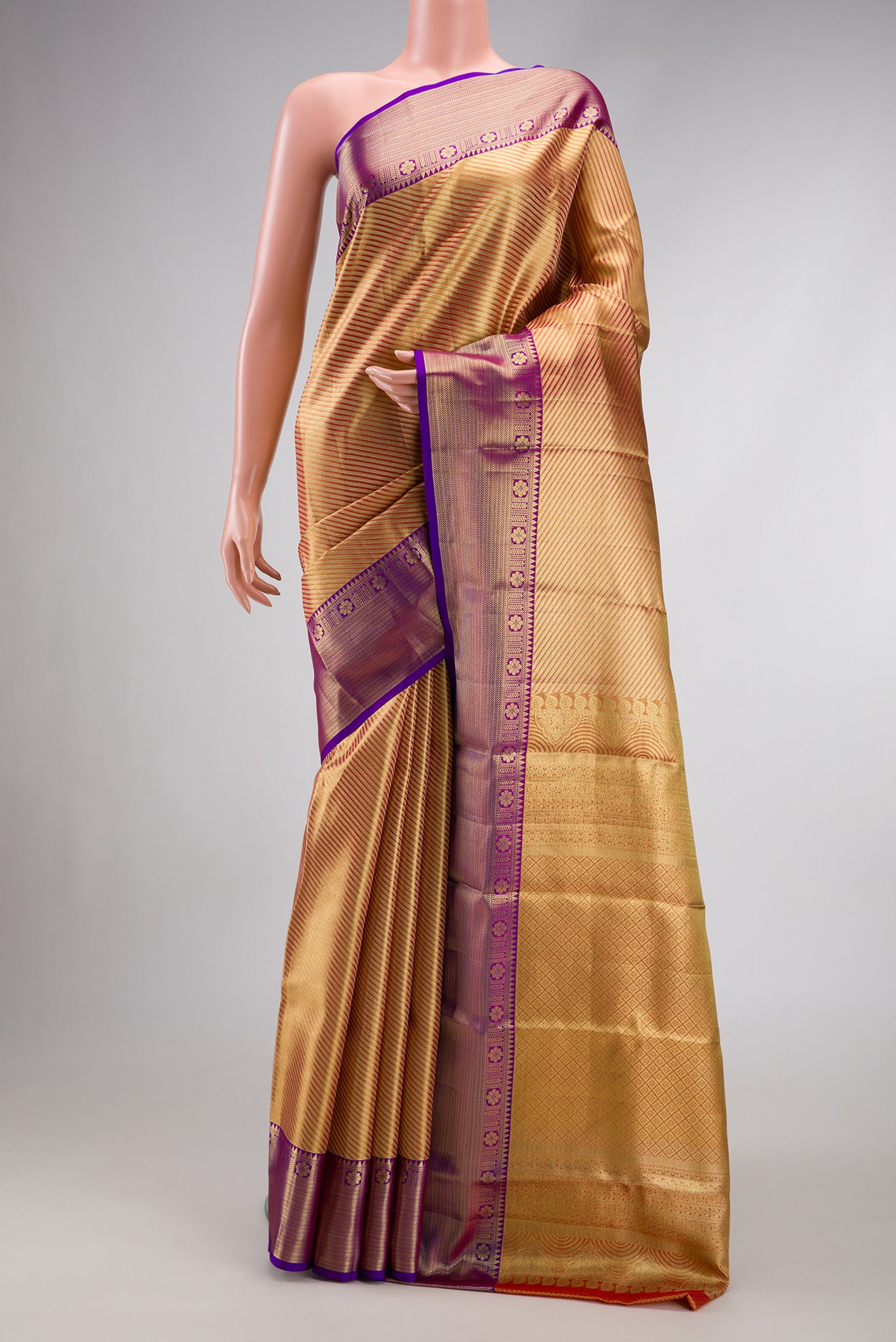 Golden Peach Dual Tone Kanchipuram Tissue Silk Saree with Zari Brocade on the body and Zari Border.  displayed on a mannequin