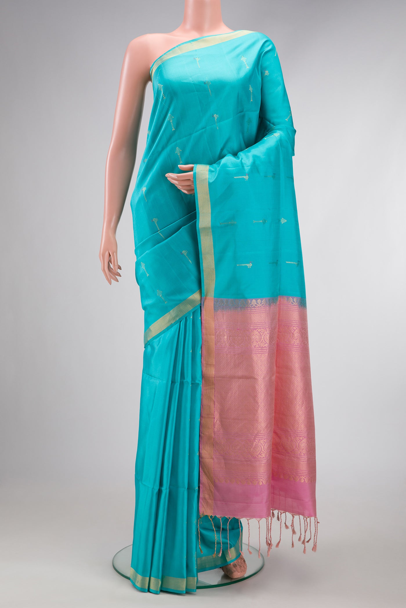 Sky Blue Soft Silk Saree with Zari Butta on the body and Zari Border.  displayed on a mannequin