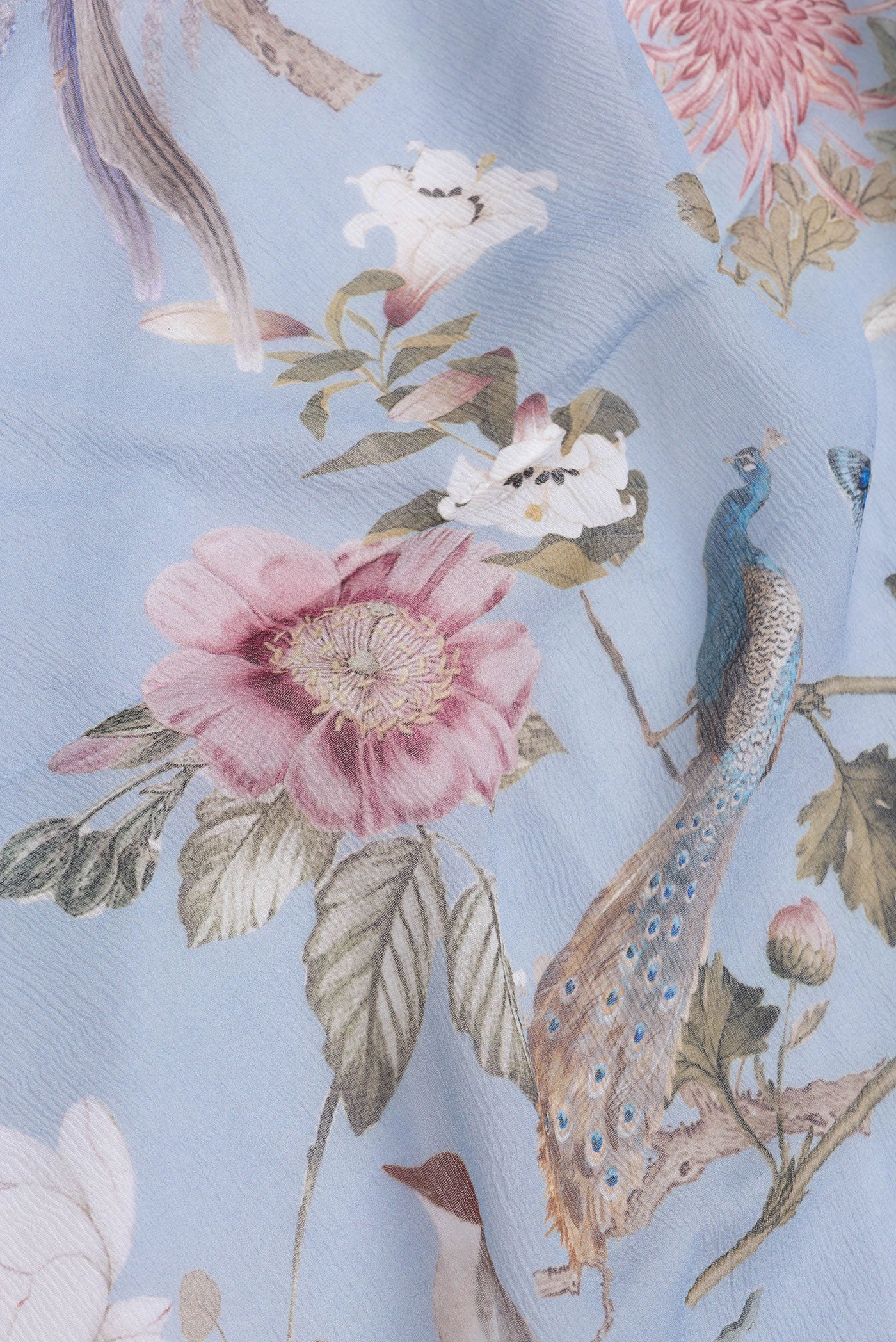 Close up of Light Blue Dual Tone Mysore Chiffon Saree with Printed design on the body and Without Border.  displaying folds