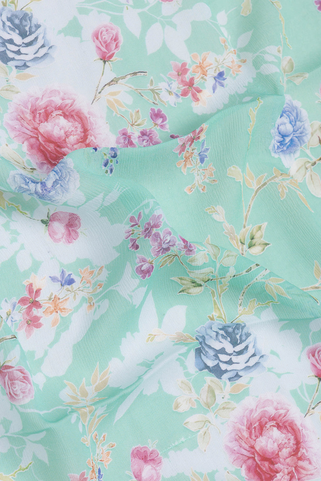 Close up of Sea Green Mysore Chiffon Saree with Printed design on the body and Plain Border.  displaying folds