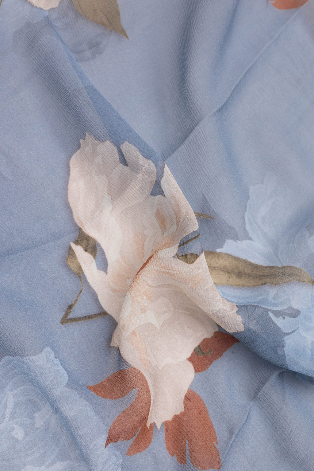 Close up of Blue Grey Mysore Chiffon Saree with Printed design on the body and Without Border.  displaying folds