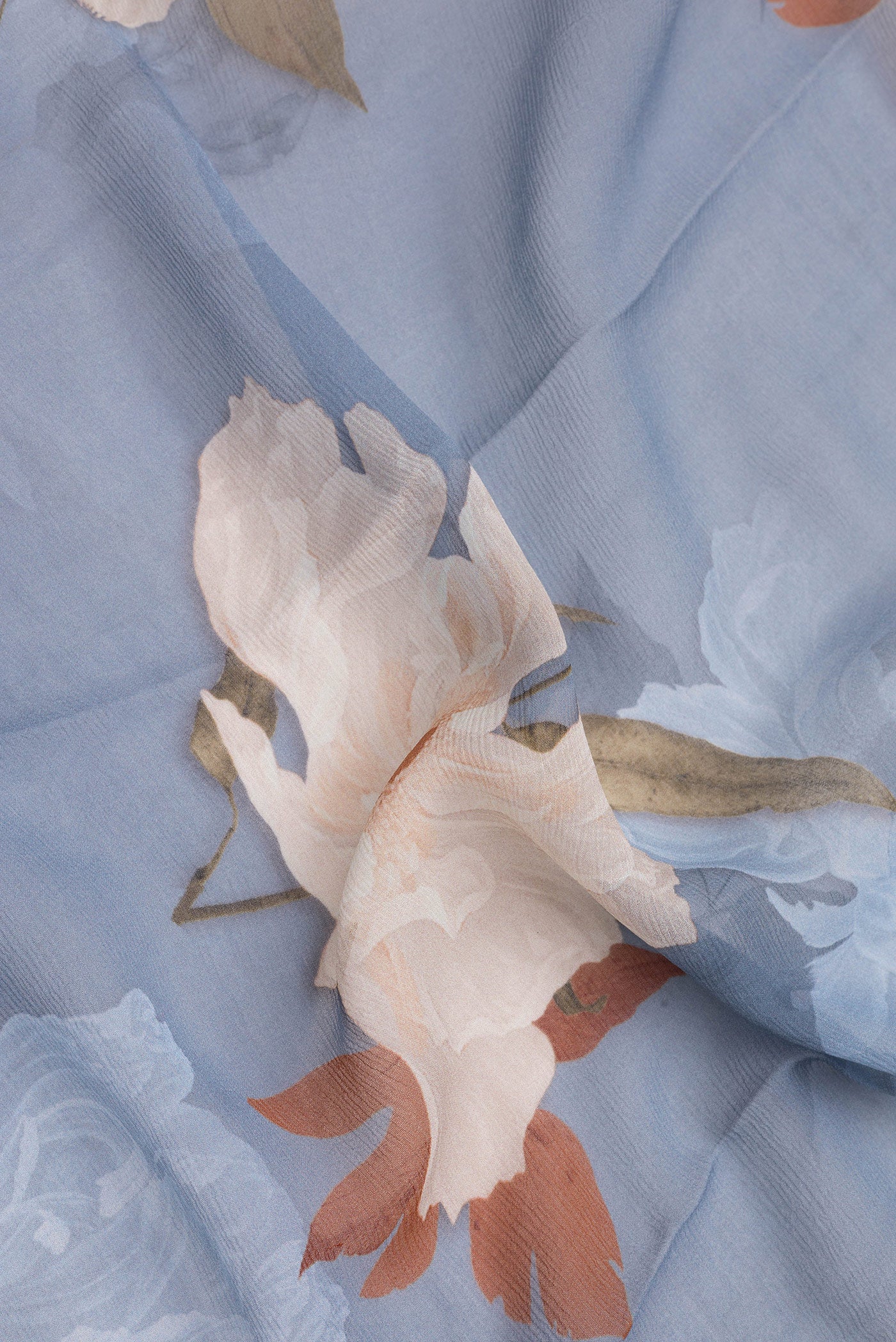 Close up of Blue Grey Mysore Chiffon Saree with Printed design on the body and Without Border.  displaying folds