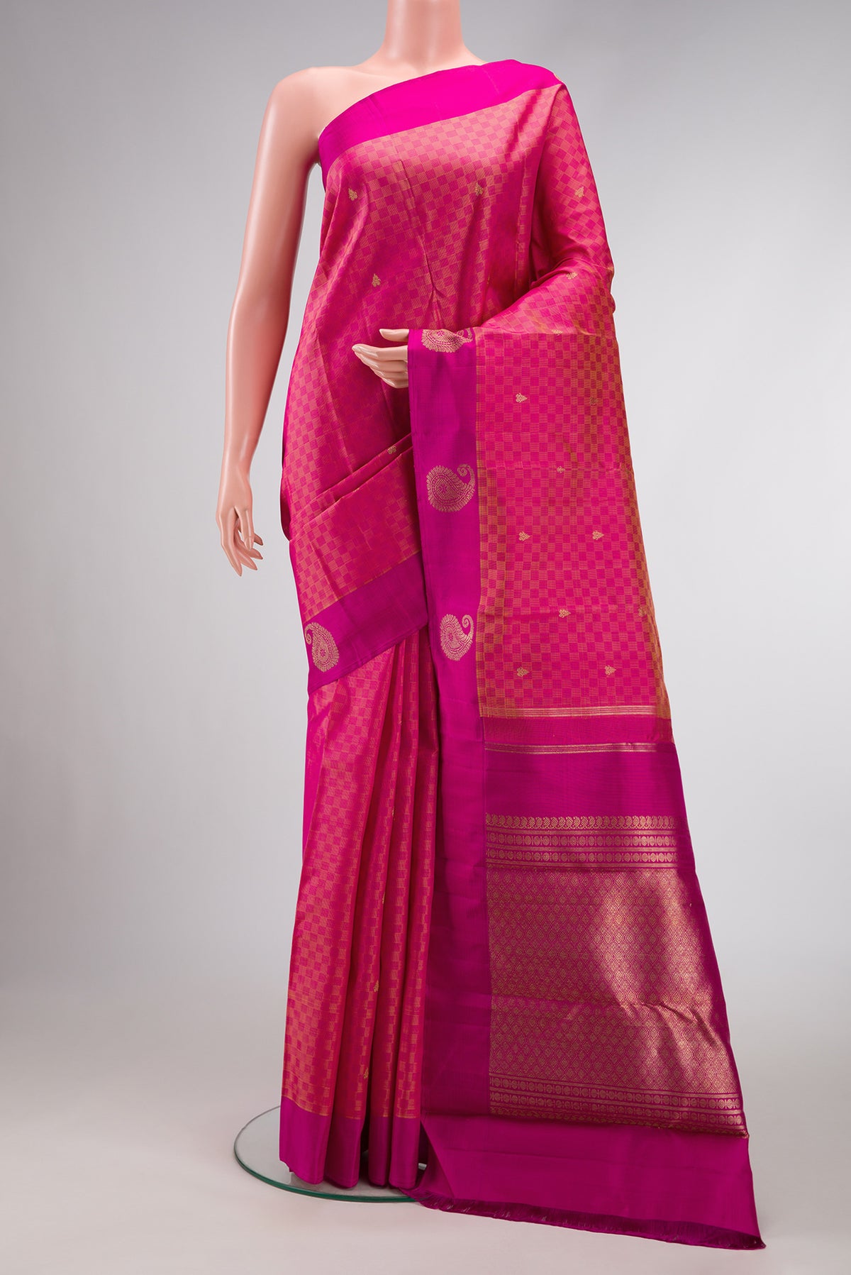 Pure Silk Pure Zari Peach Dual Tone Kanchipuram Saree with Zari Butta on the body and Fancy Border.  displayed on a mannequin