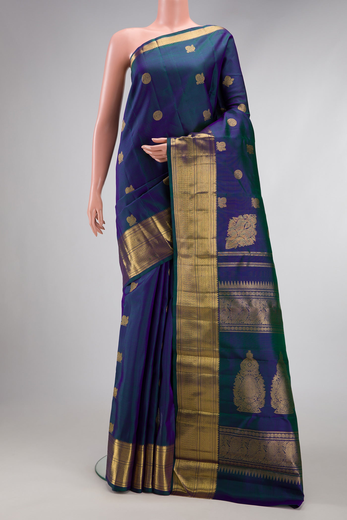 Pure Silk Pure Zari Peacock Blue Dual Tone Kanjivaram Saree with Zari Butta on the body and Zari Border.  displayed on a mannequin