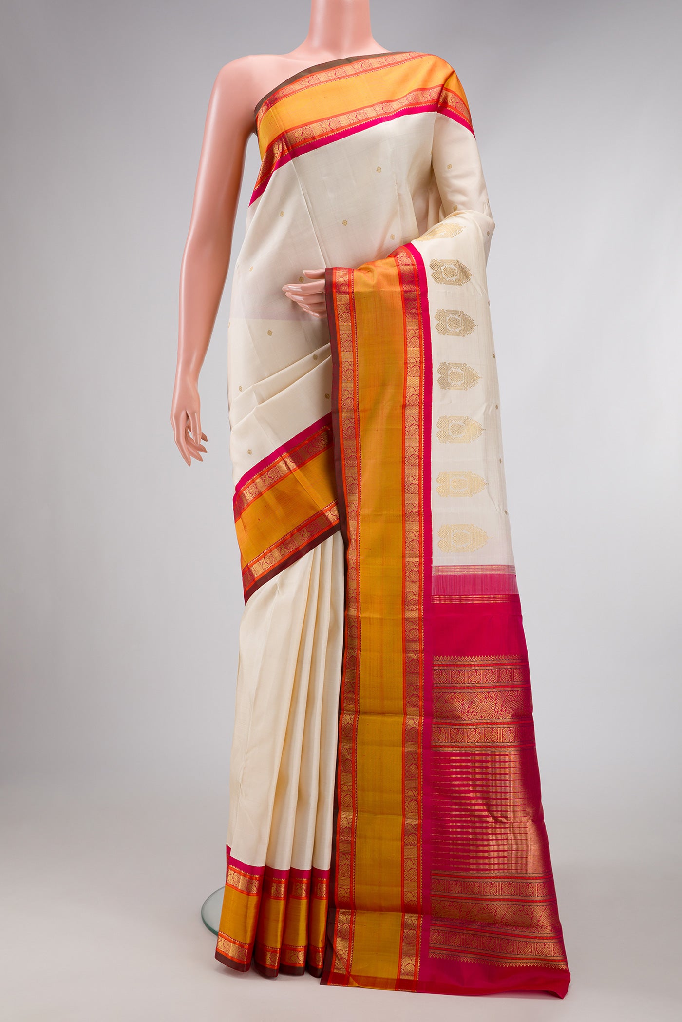 Pure Silk Pure Zari Off White Dual Tone Kanjivaram Saree with Zari Butta on the body and Fancy Border.  displayed on a mannequin