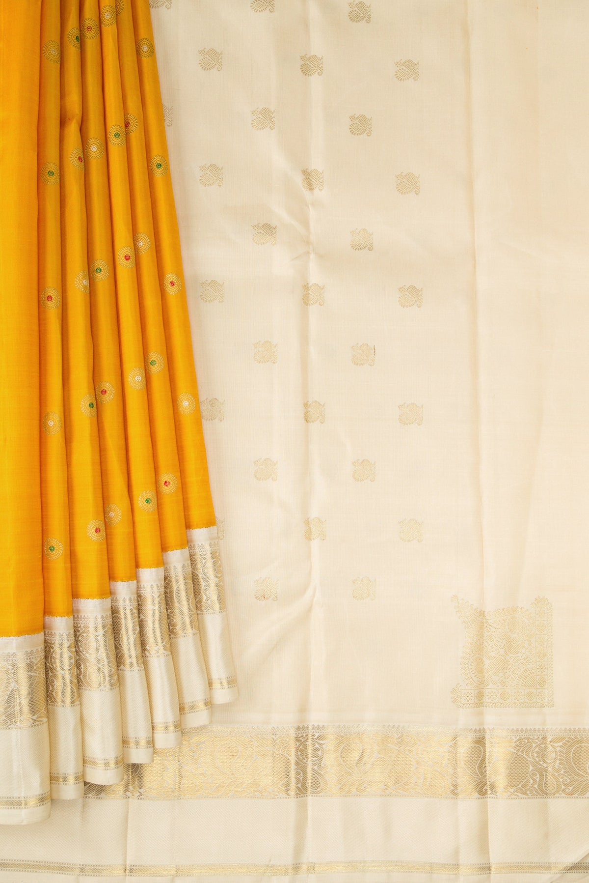 Pleats and pallu of Pure Silk Pure Zari Mustard Dual Tone Kanjivaram Saree with Zari And Thread Butta on the body and Zari Border. 