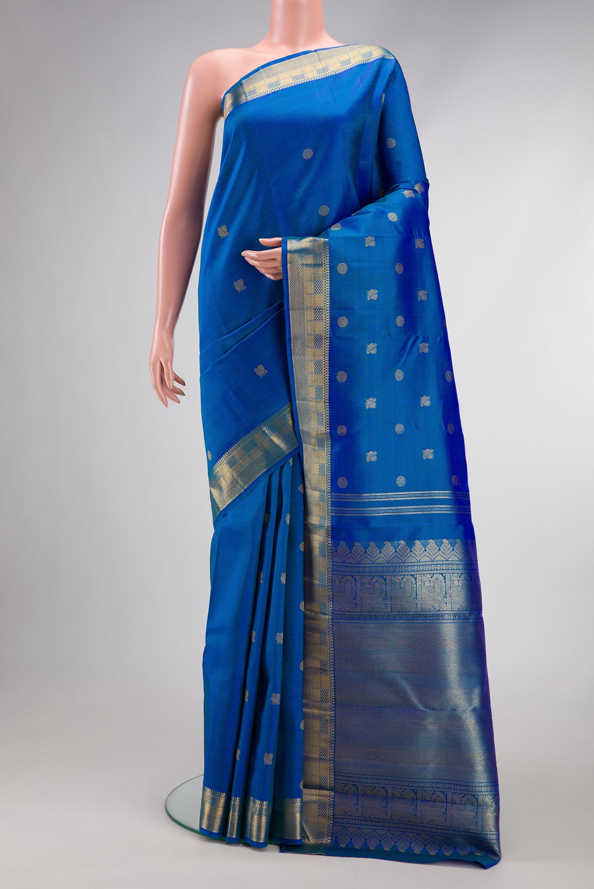 Pure Silk Pure Zari Peacock Blue Dual Tone Kanjivaram Saree with Zari Butta on the body and Zari Border.  displayed on a mannequin
