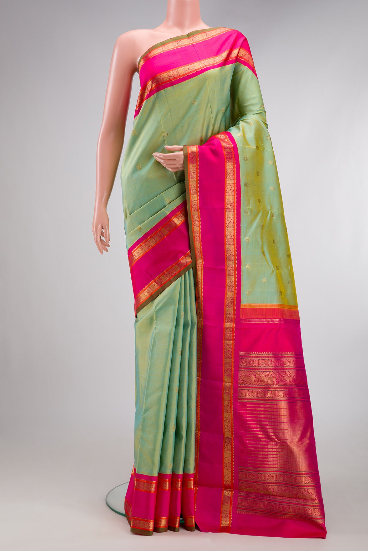 Pure Silk Pure Zari Pista Green Kanjivaram Saree with Zari Butta on the body and Zari Border.  displayed on a mannequin