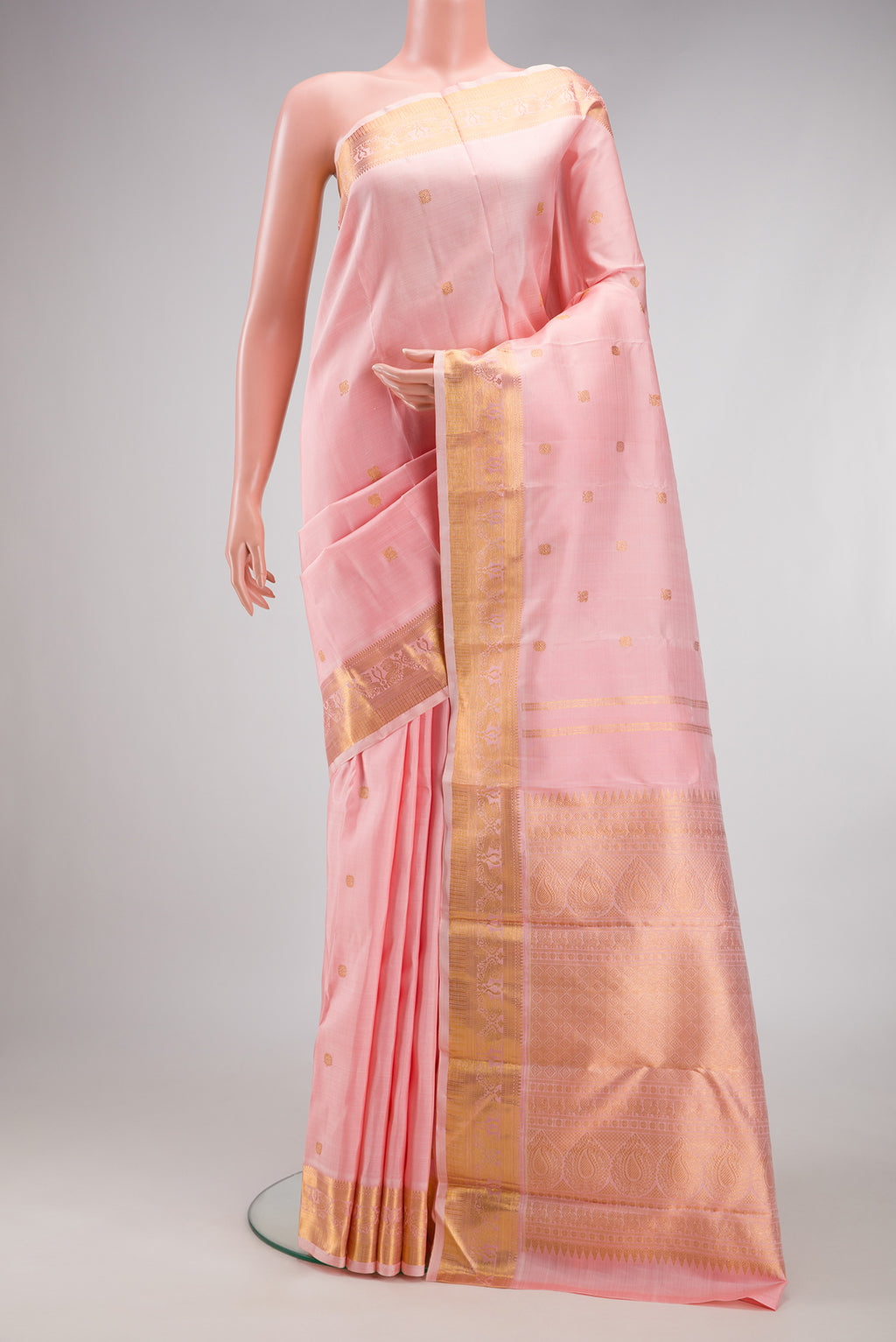 Pure Silk Pure Zari Rose pink Kanjivaram Saree with Zari Butta on the body and Zari Border.  displayed on a mannequin