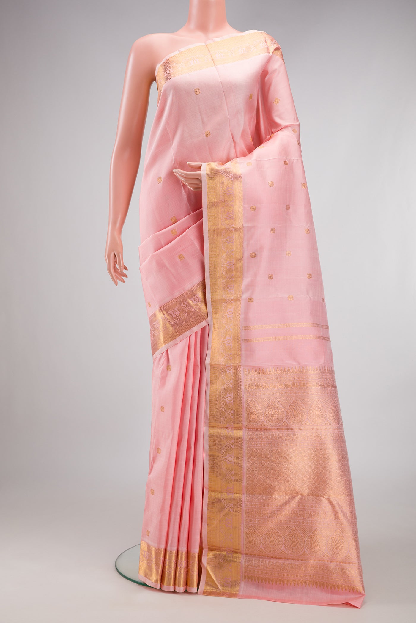 Pure Silk Pure Zari Rose pink Kanjivaram Saree with Zari Butta on the body and Zari Border.  displayed on a mannequin