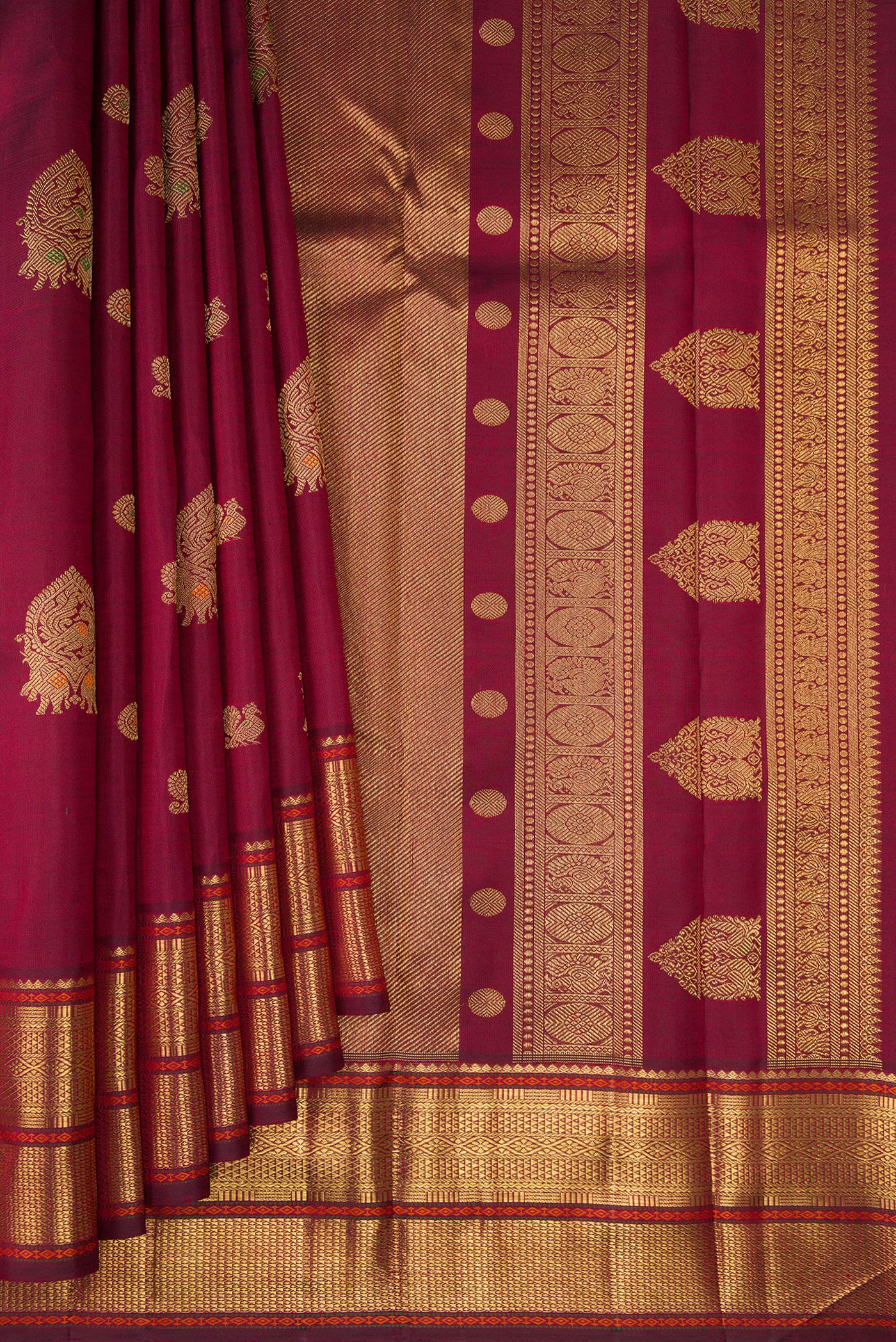Pleats and pallu of Pure Silk Pure Zari Maroon Kanjivaram Saree with Zari Butta on the body and Zari Border. 