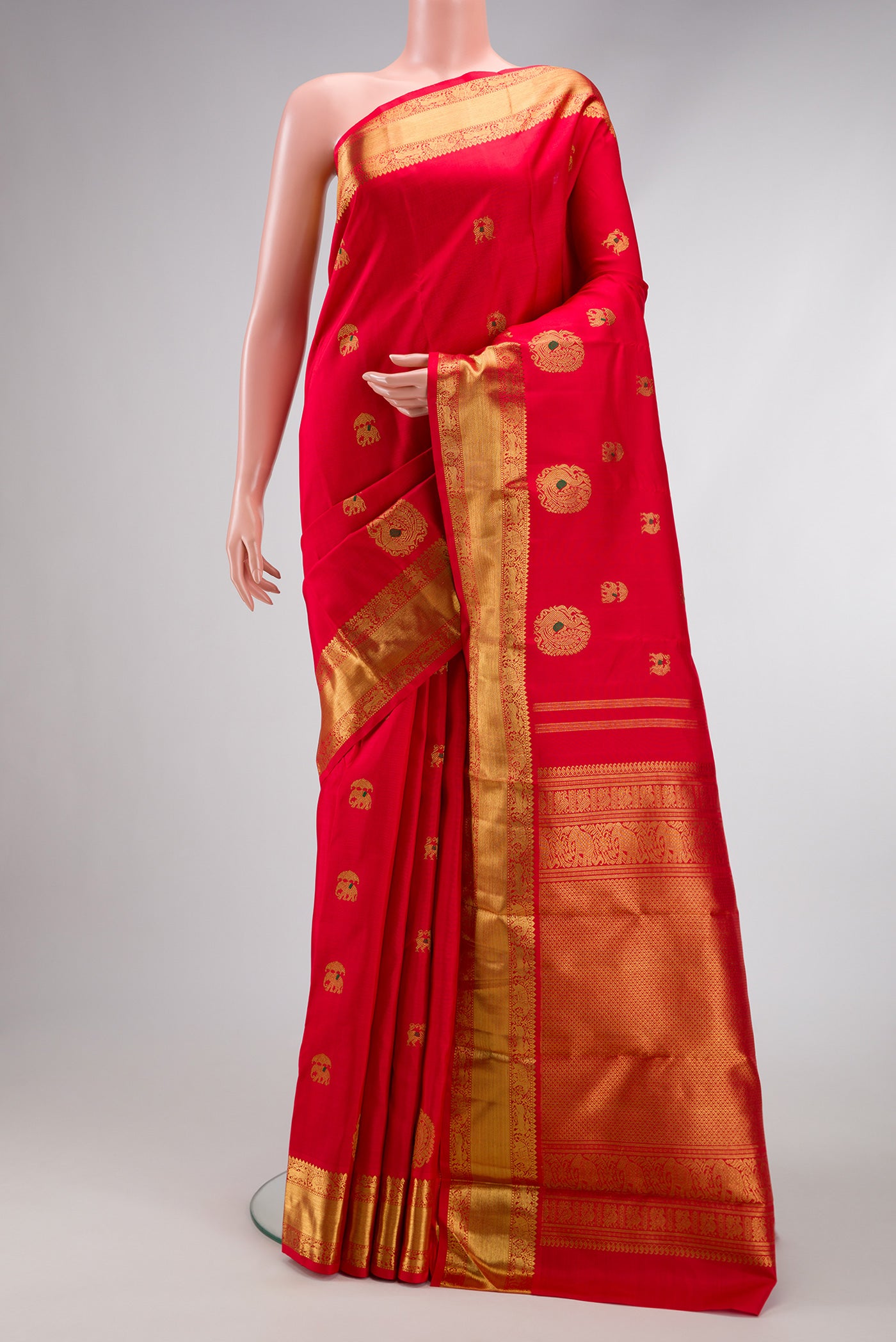 Pure Silk Pure Zari Red Dual Tone Kanjivaram Saree with Zari And Thread Butta on the body and Zari Border.  displayed on a mannequin
