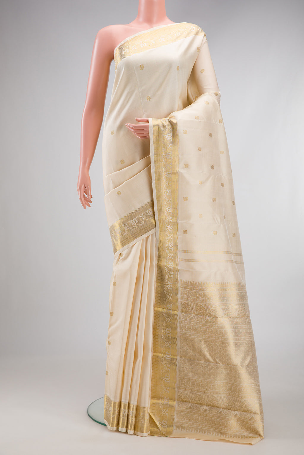 Pure Silk Pure Zari Cream Kanjivaram Saree with Zari Butta on the body and Fancy Border.  displayed on a mannequin