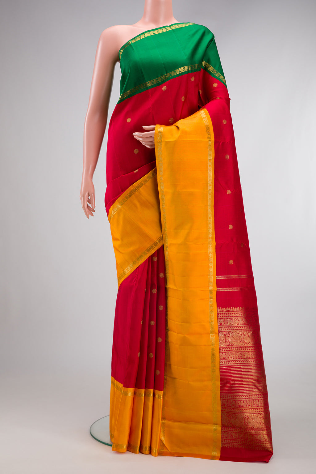 Pure Silk Pure Zari Red Kanjivaram Saree with Zari Butta on the body and Ganga Jamuna Border.  displayed on a mannequin