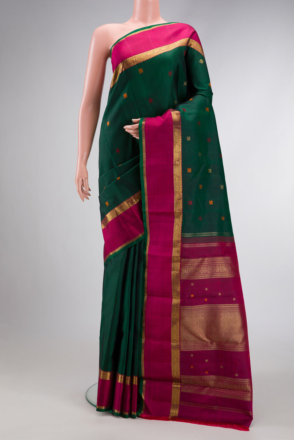 Pure Silk Pure Zari Bottle Green Dual Tone Kanchipuram Saree with Zari And Thread Butta on the body and Zari Border.  displayed on a mannequin