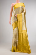 Silver Dual Tone Kanjivaram Tissue Silk Saree with Zari Brocade on the body and Zari Border.  displayed on a mannequin