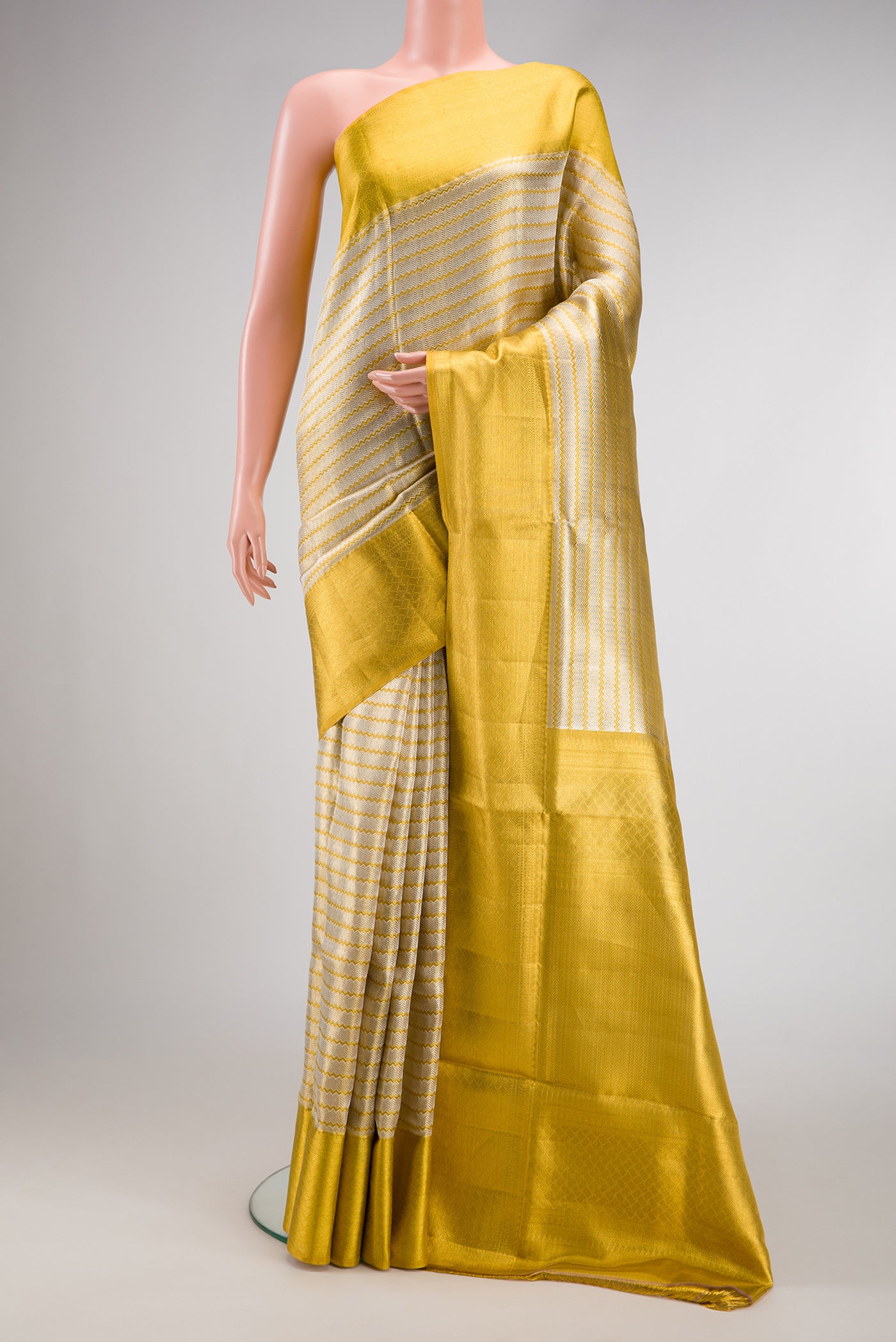 Silver Dual Tone Kanjivaram Tissue Silk Saree with Zari Brocade on the body and Zari Border.  displayed on a mannequin