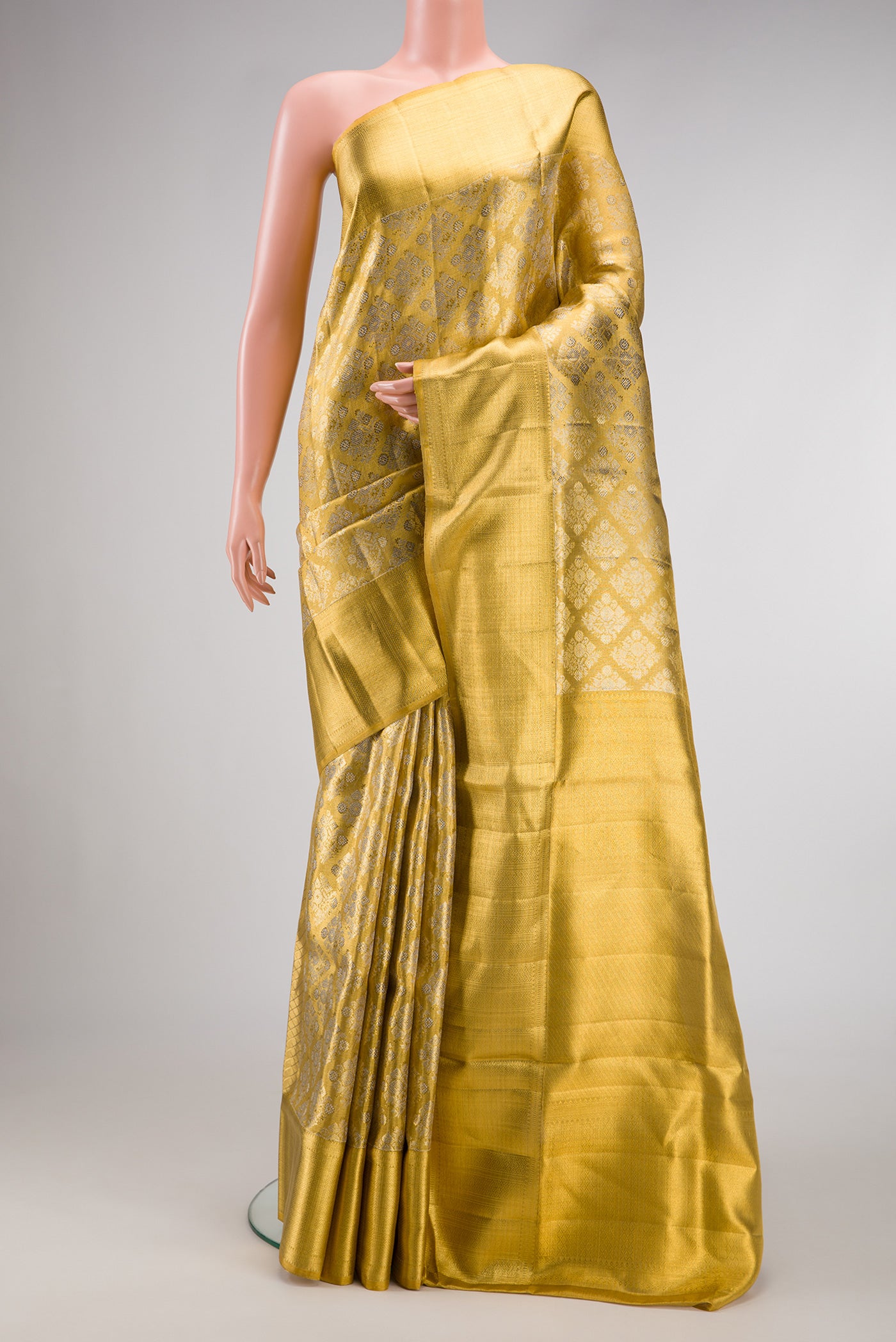 Gold Dual Tone Kanjivaram Tissue Silk Saree with Zari Brocade on the body and Zari Border.  displayed on a mannequin