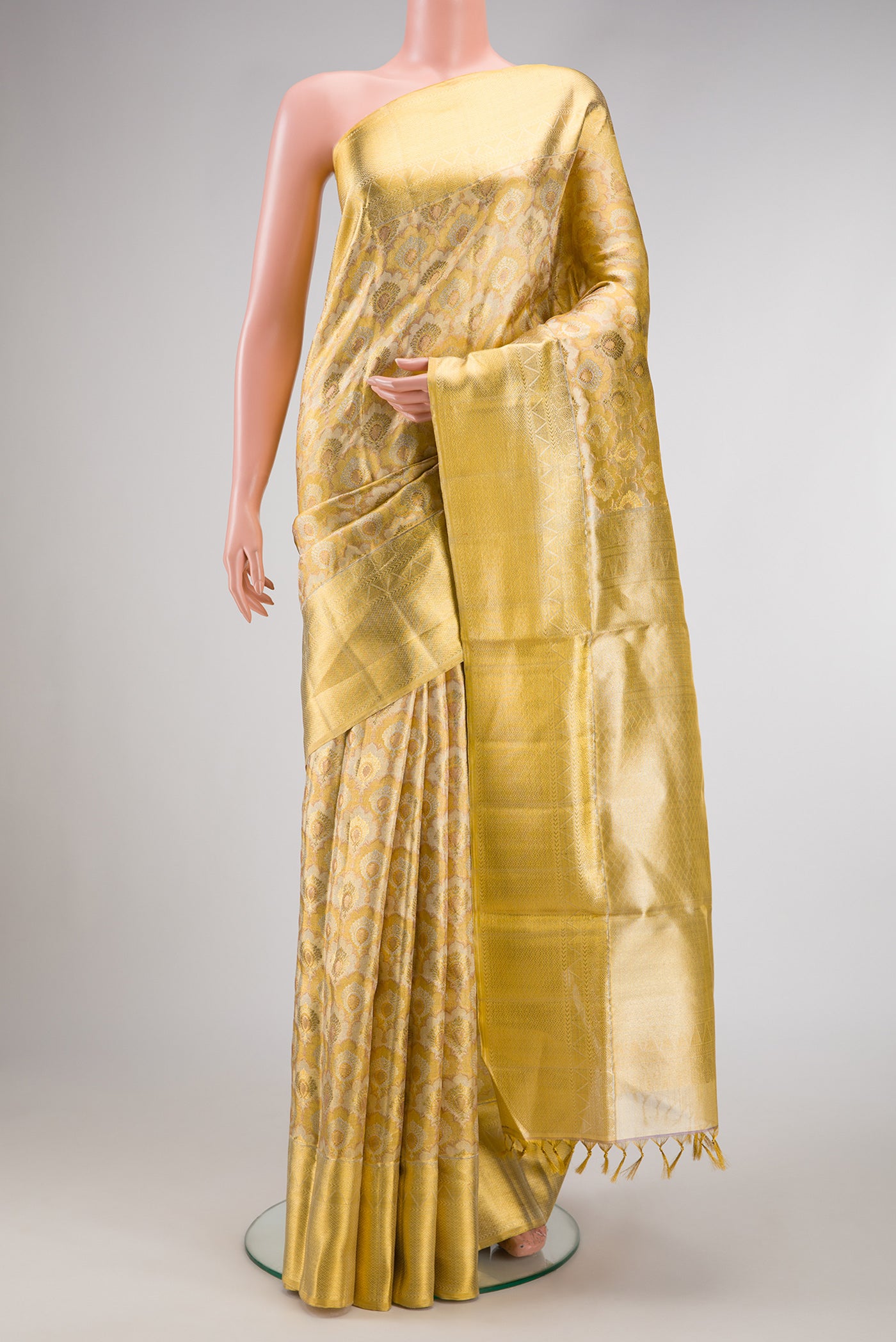 Gold Dual Tone Kanjivaram Tissue Silk Saree with Zari Brocade on the body and Zari Border.  displayed on a mannequin