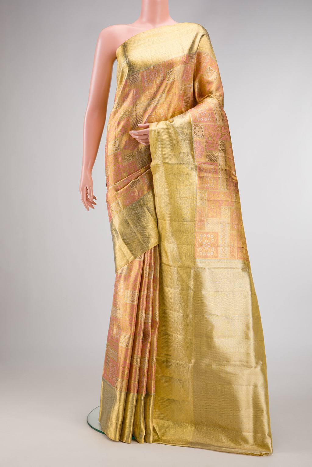 Rose Gold Dual Tone Kanjivaram Tissue Silk Saree with Zari Brocade on the body and Zari Border.  displayed on a mannequin