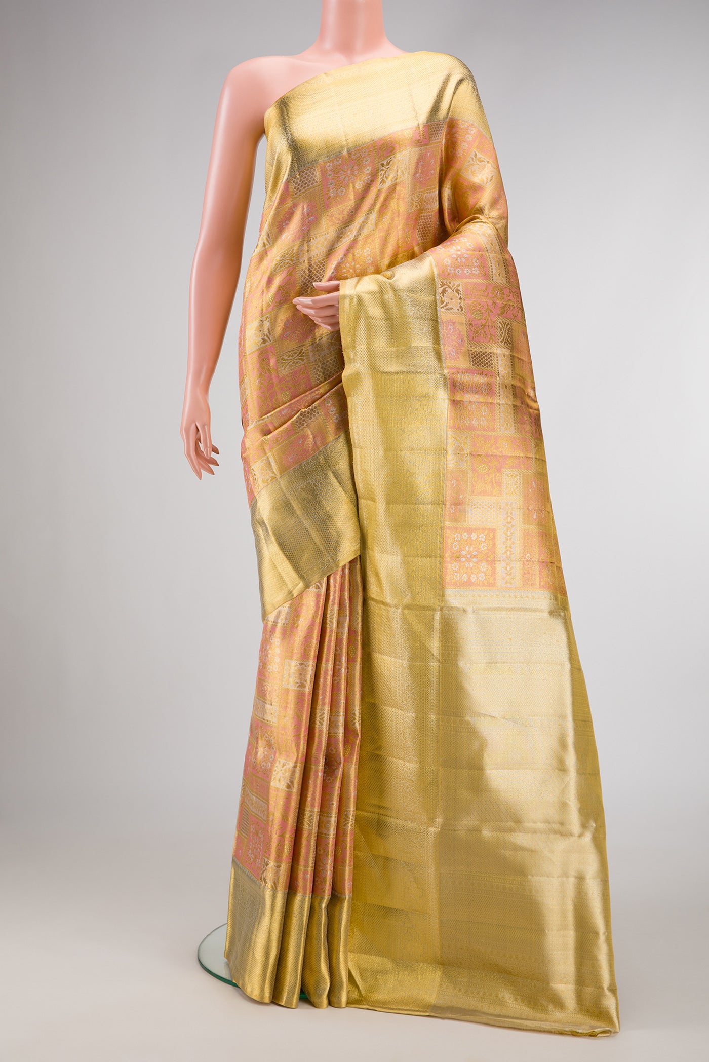 Rose Gold Dual Tone Kanjivaram Tissue Silk Saree with Zari Brocade on the body and Zari Border.  displayed on a mannequin