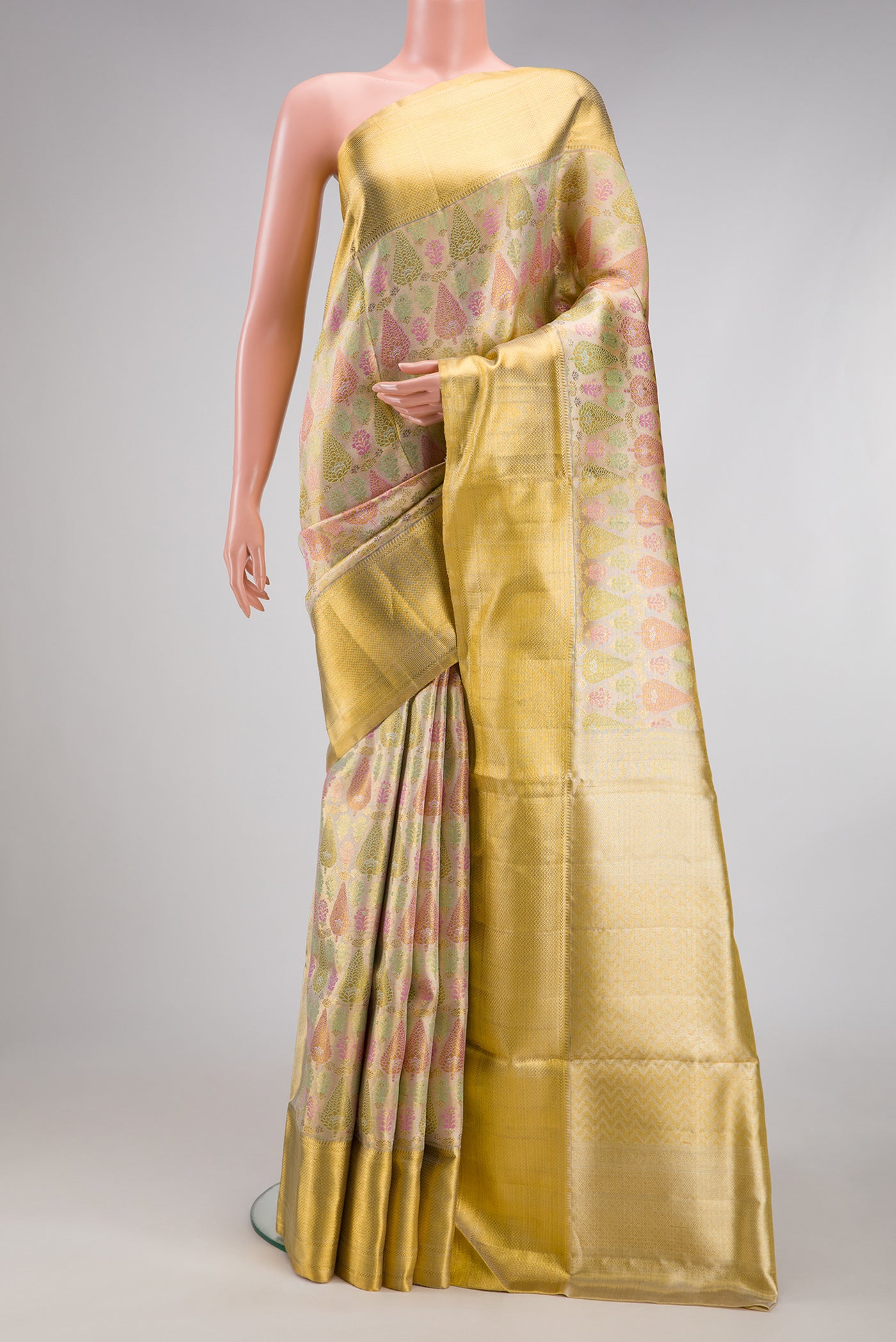 Gold Dual Tone Kanjivaram Tissue Silk Saree with Zari Brocade on the body and Zari Border.  displayed on a mannequin