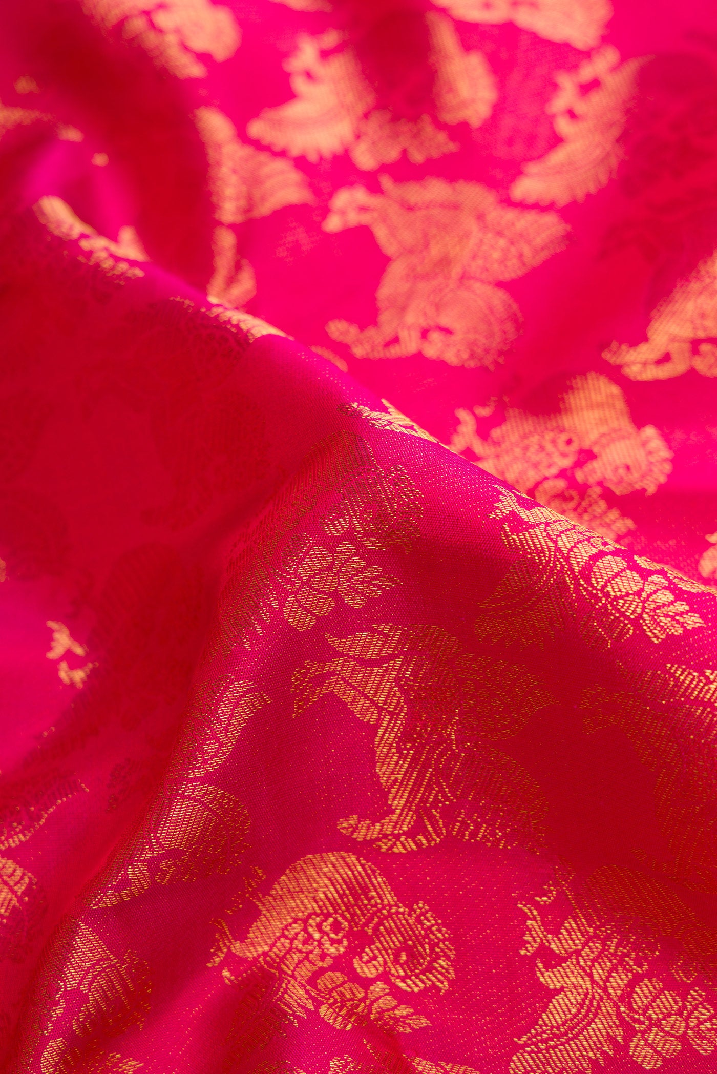 Close up of Pink Dual Tone Kanchipuram Silk Saree with Zari Brocade on the body and Zari Border.  displaying folds