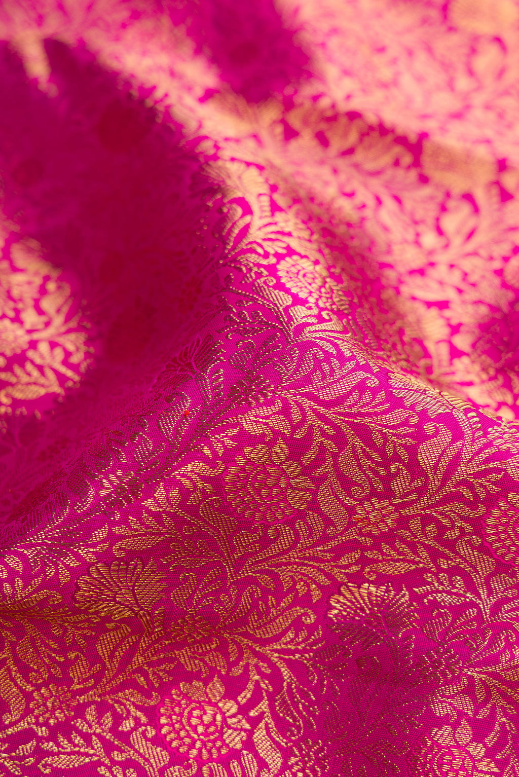 Close up of Pink Dual Tone Kanjivaram Silk Saree with Zari Brocade on the body and Zari Border.  displaying folds