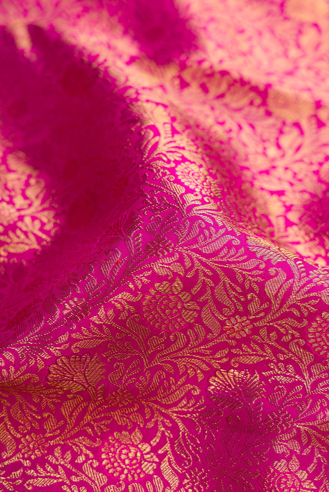 Close up of Pink Dual Tone Kanjivaram Silk Saree with Zari Brocade on the body and Zari Border.  displaying folds
