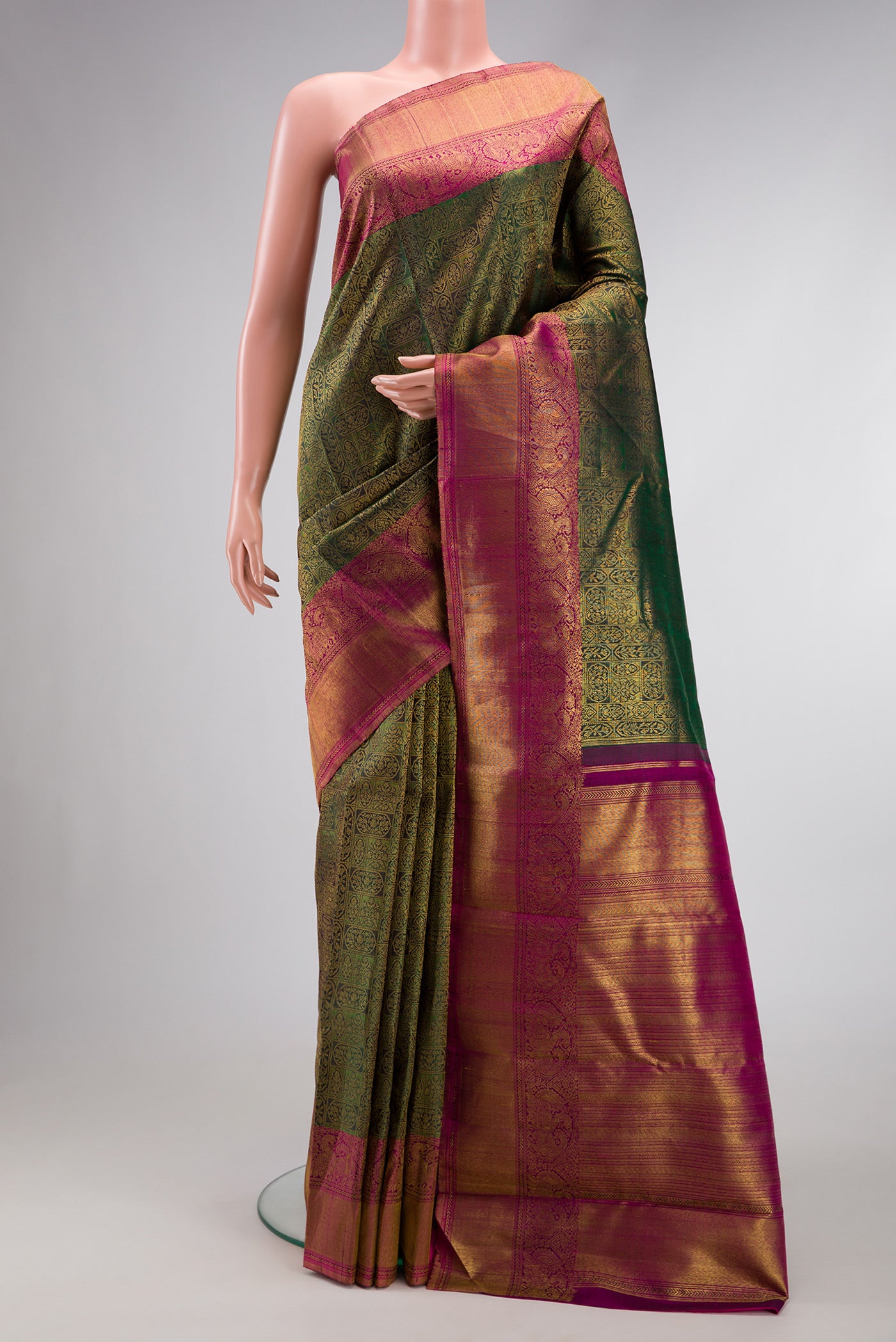 Green Dual Tone Kanchipuram Silk Saree with Zari Brocade on the body and Zari Border.  displayed on a mannequin