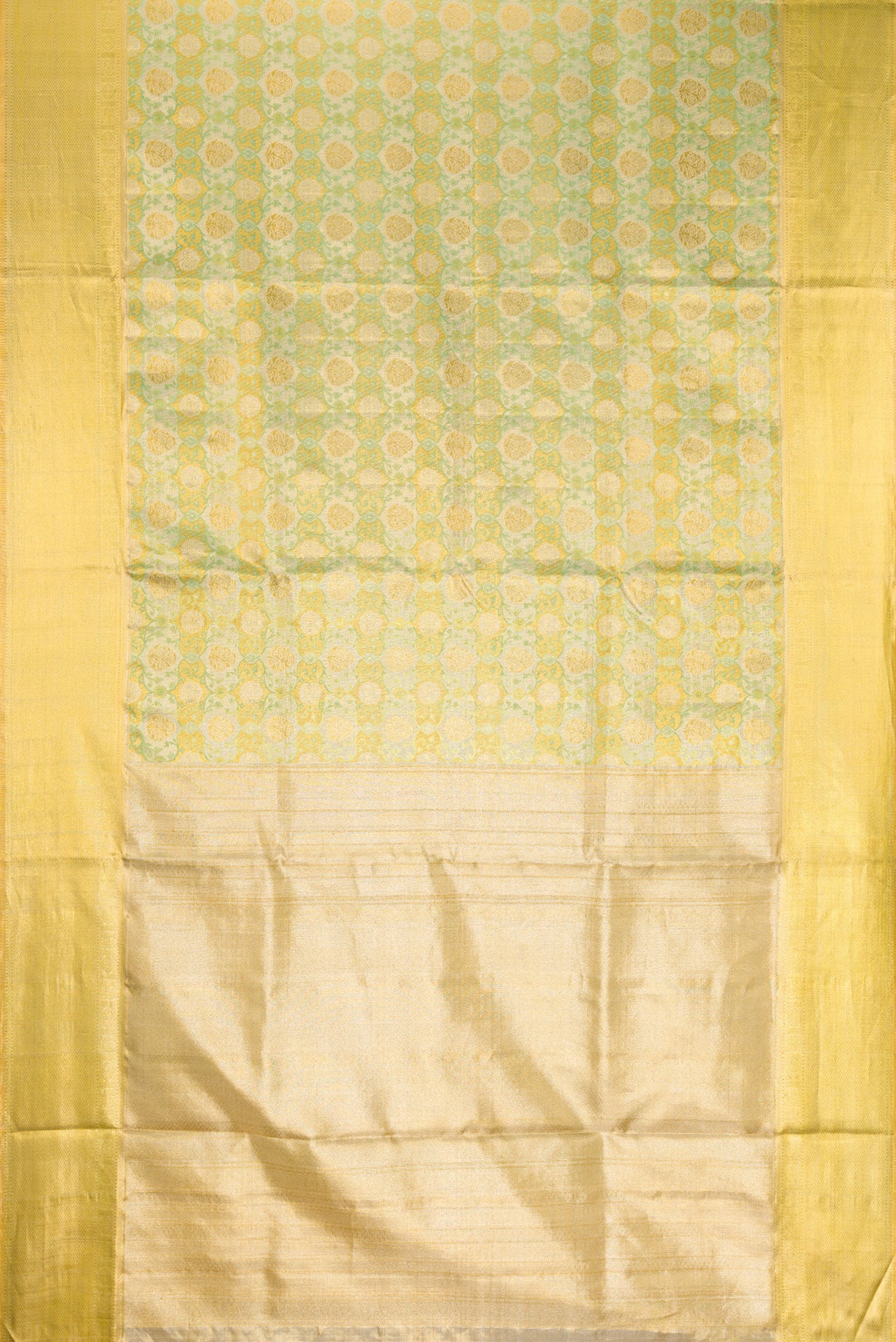 Flat view of Pista Green Dual Tone Kanjivaram Tissue Silk Saree with Zari Brocade on the body and Zari Border. 