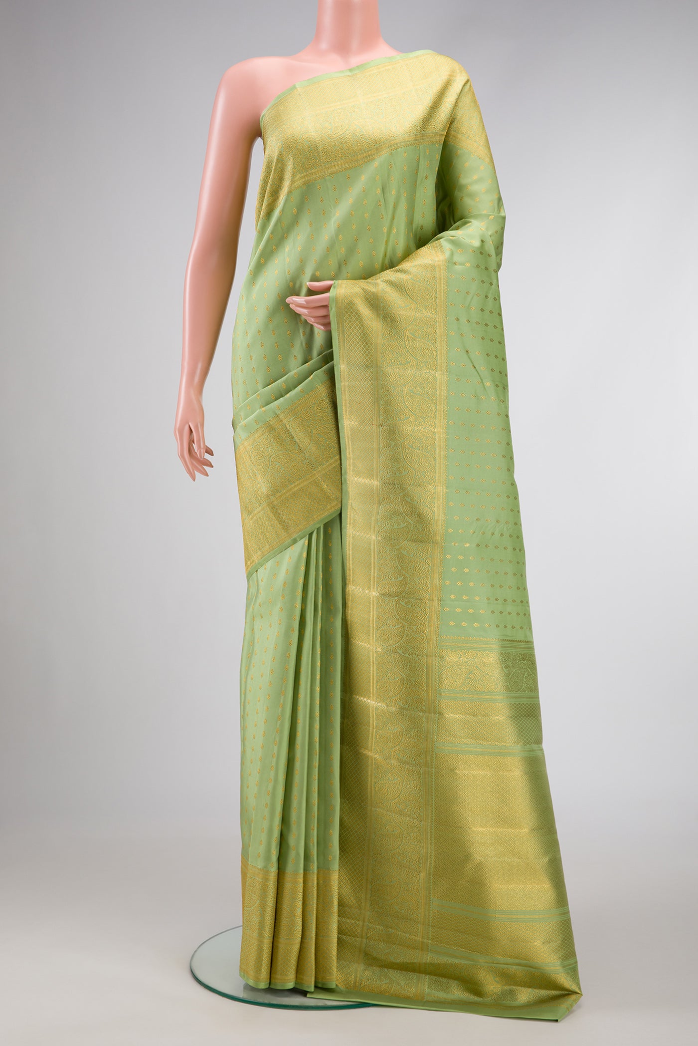 Pista Green Dual Tone Kanjivaram Silk Saree with Zari Butta on the body and Fancy Border.  displayed on a mannequin