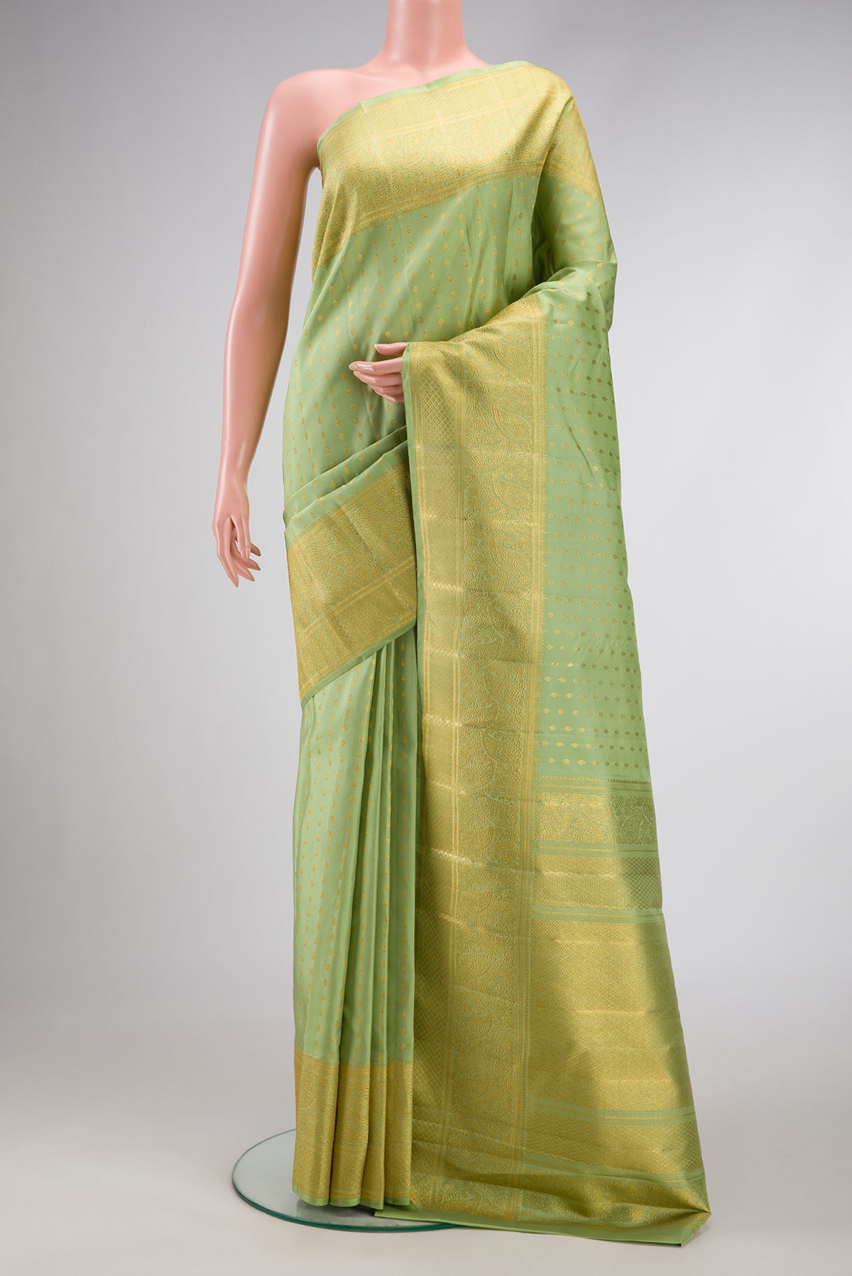Pista Green Dual Tone Kanjivaram Silk Saree with Zari Butta on the body and Fancy Border.  displayed on a mannequin