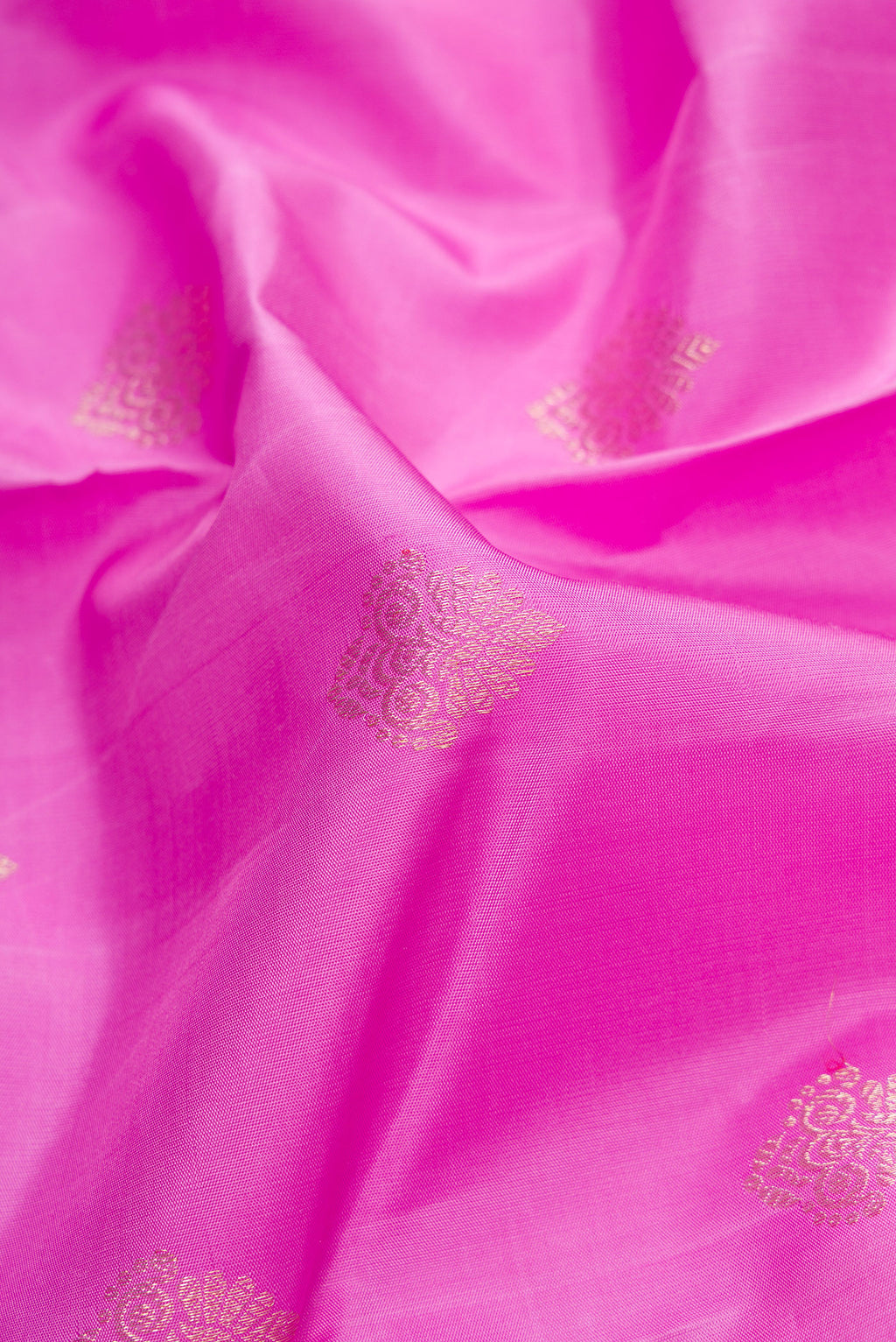 Close up of Pink Dual Tone Kanjivaram Silk Saree with Zari Butta on the body and Fancy Border.  displaying folds