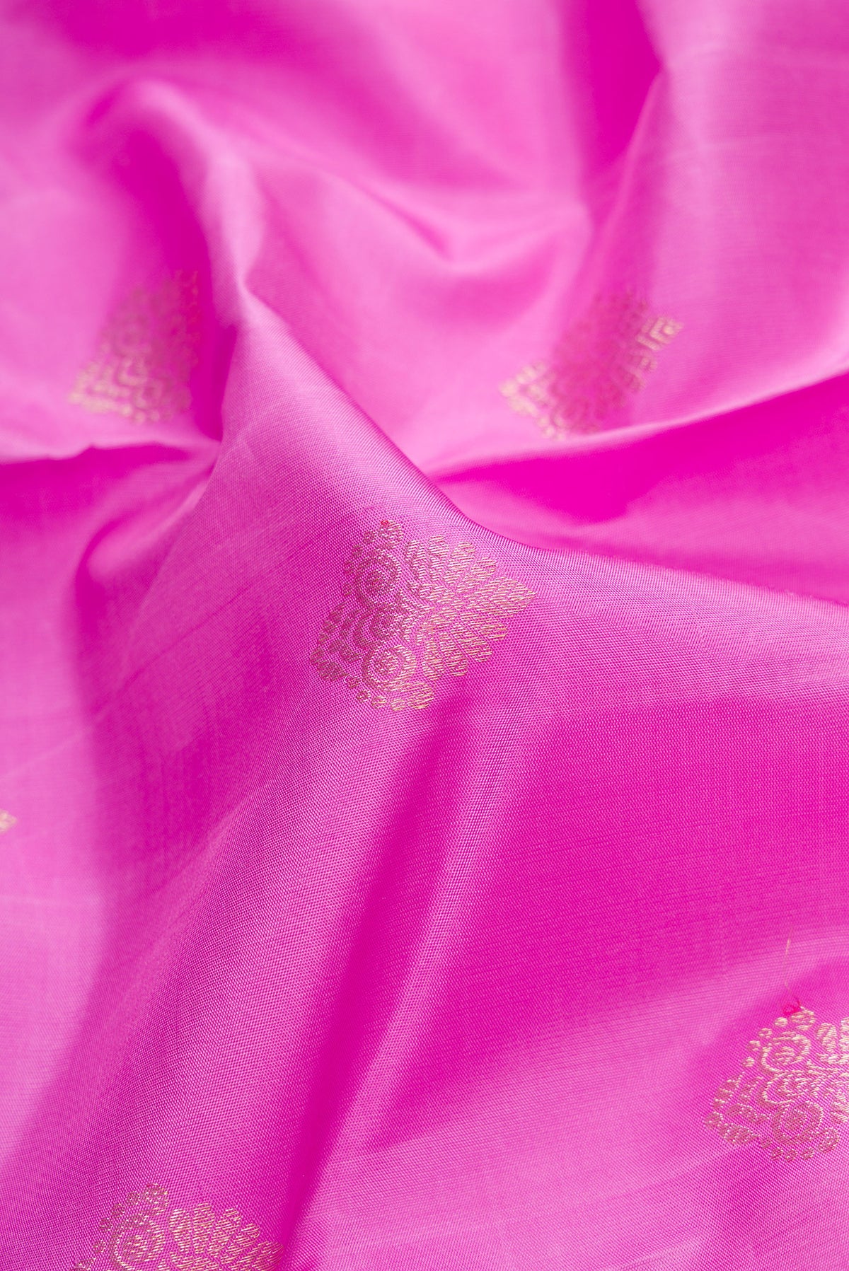 Close up of Pink Dual Tone Kanjivaram Silk Saree with Zari Butta on the body and Fancy Border.  displaying folds