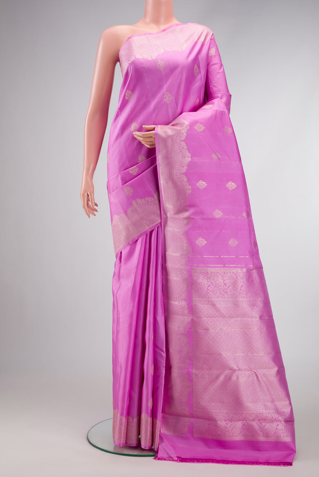 Pink Dual Tone Kanjivaram Silk Saree with Zari Butta on the body and Fancy Border.  displayed on a mannequin