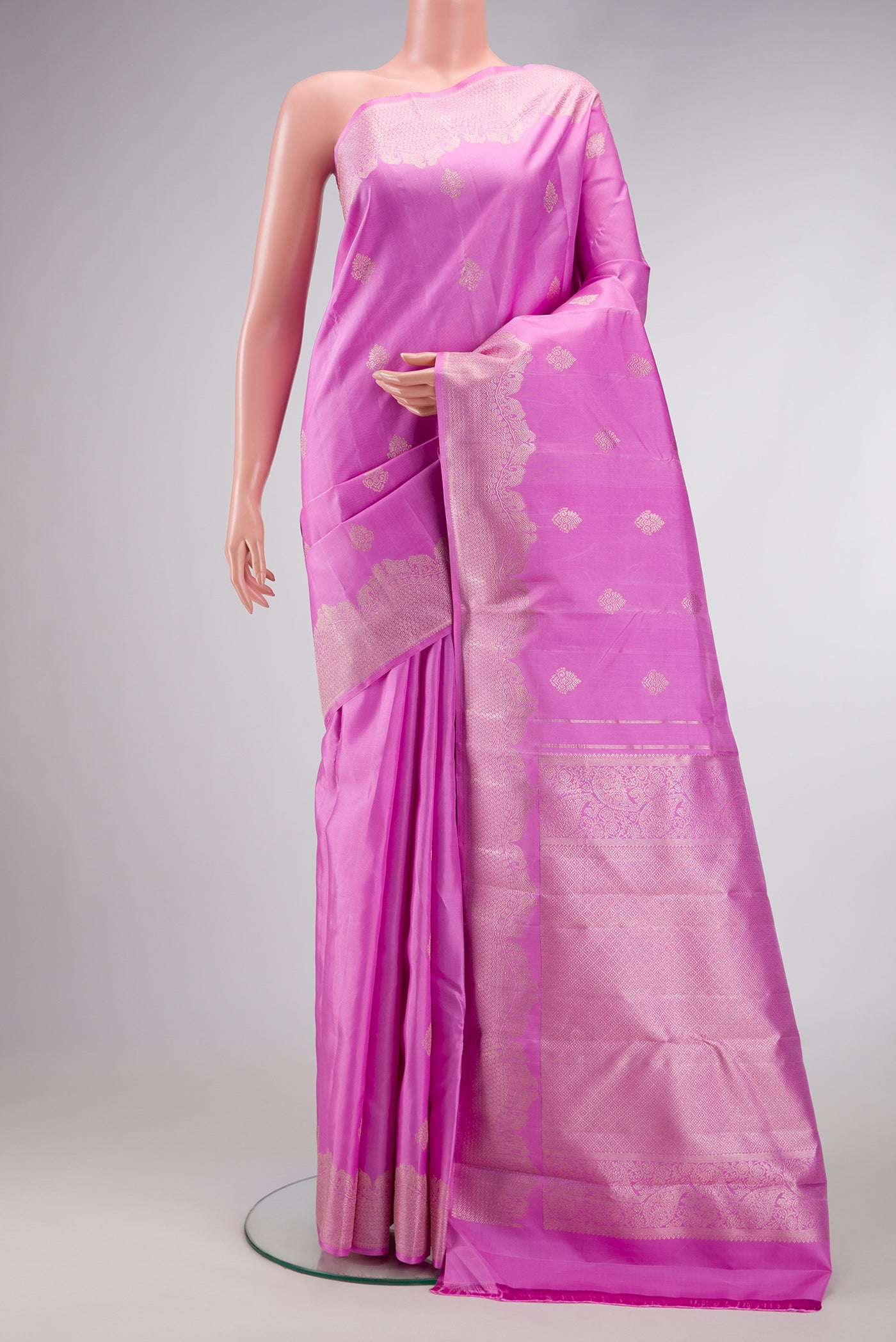Pink Dual Tone Kanjivaram Silk Saree with Zari Butta on the body and Fancy Border.  displayed on a mannequin