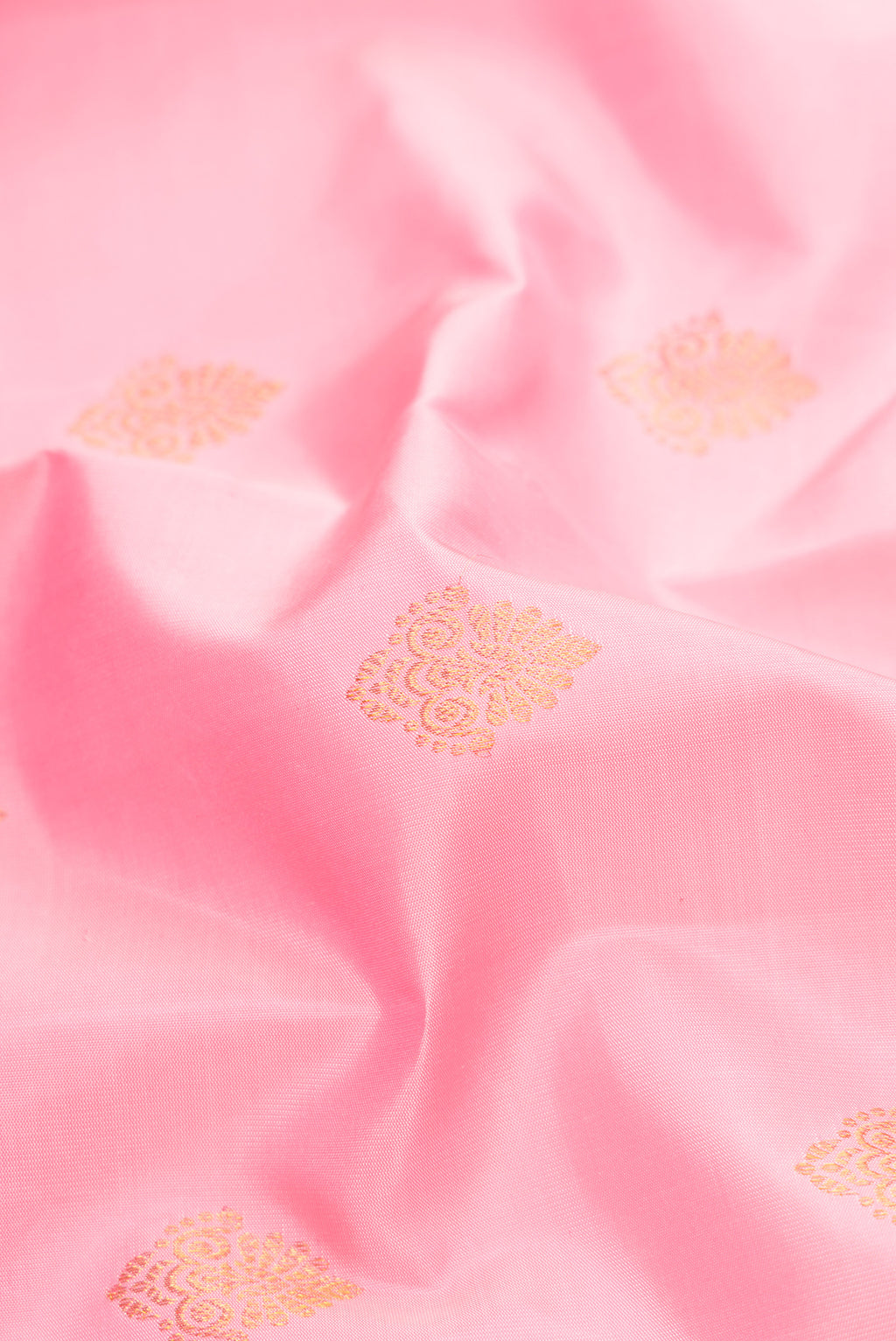 Close up of Pink Dual Tone Kanjivaram Silk Saree with Zari Butta on the body and Fancy Border.  displaying folds