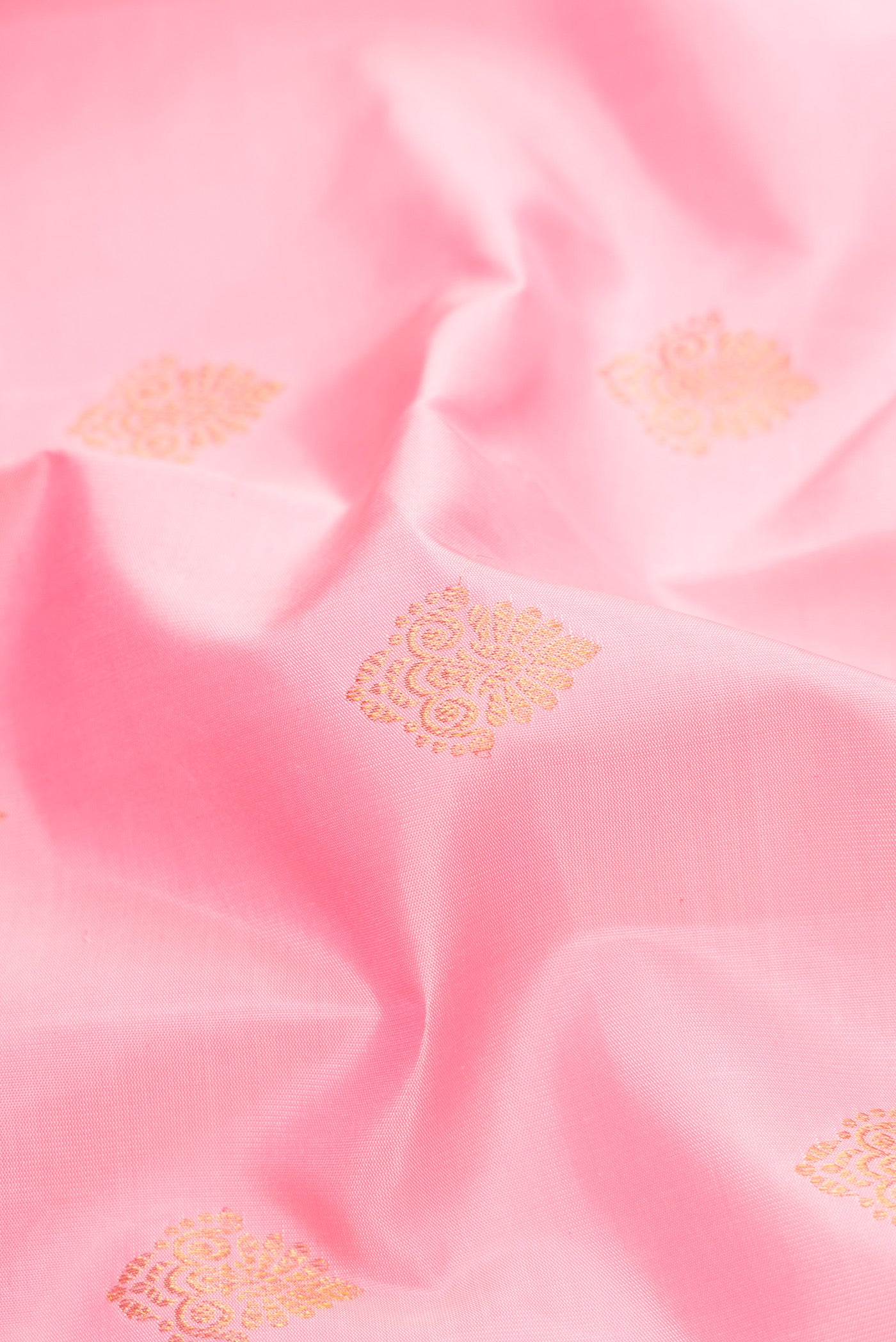 Close up of Pink Dual Tone Kanjivaram Silk Saree with Zari Butta on the body and Fancy Border.  displaying folds