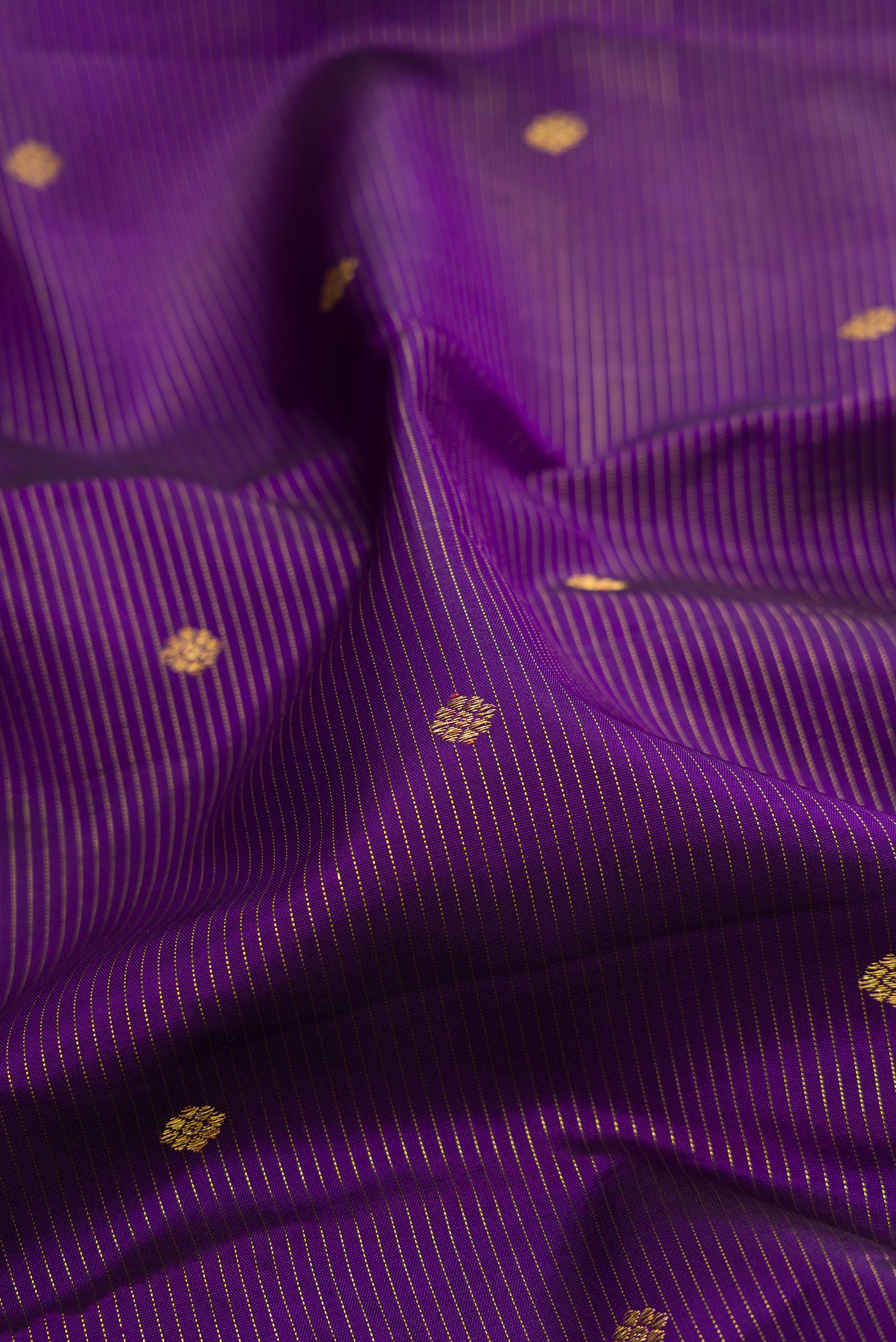 Close up of Violet Kanjivaram Silk Saree with Stripes on the body and Fancy Border.  displaying folds