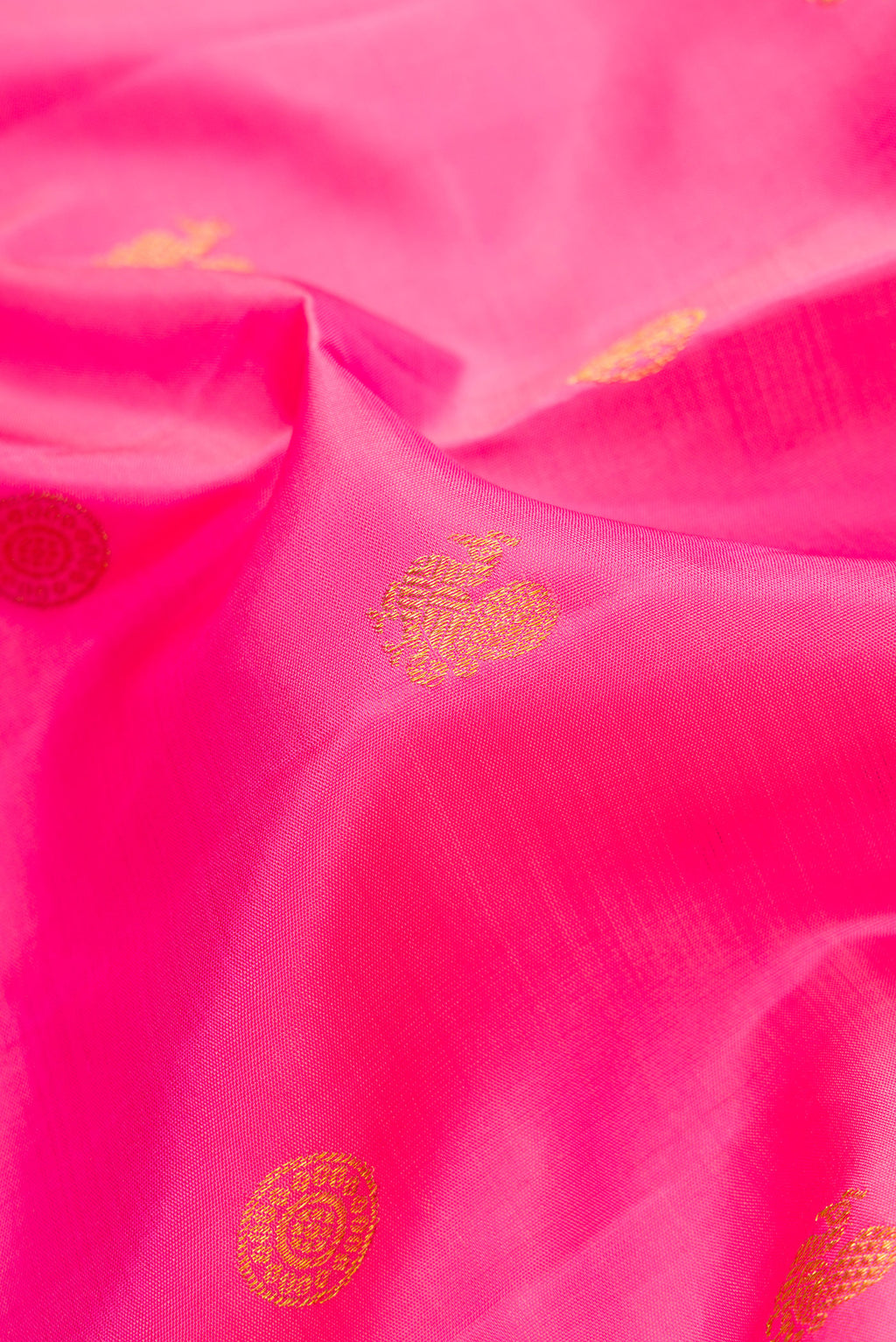 Close up of Pink Dual Tone Kanjivaram Silk Saree with Zari Butta on the body and Fancy Border.  displaying folds