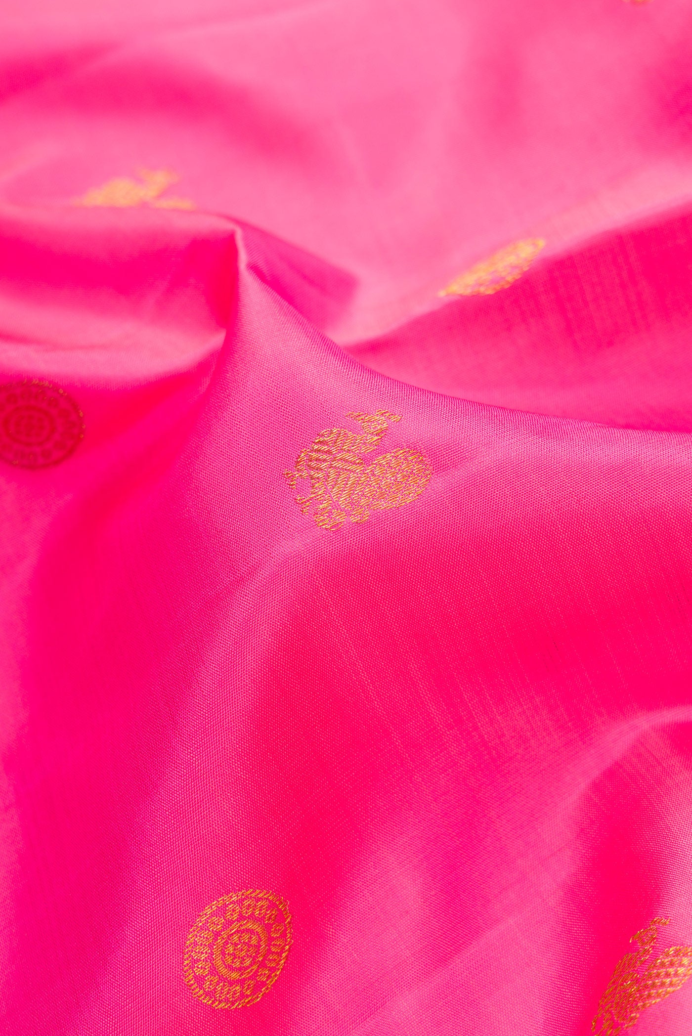 Close up of Pink Dual Tone Kanjivaram Silk Saree with Zari Butta on the body and Fancy Border.  displaying folds