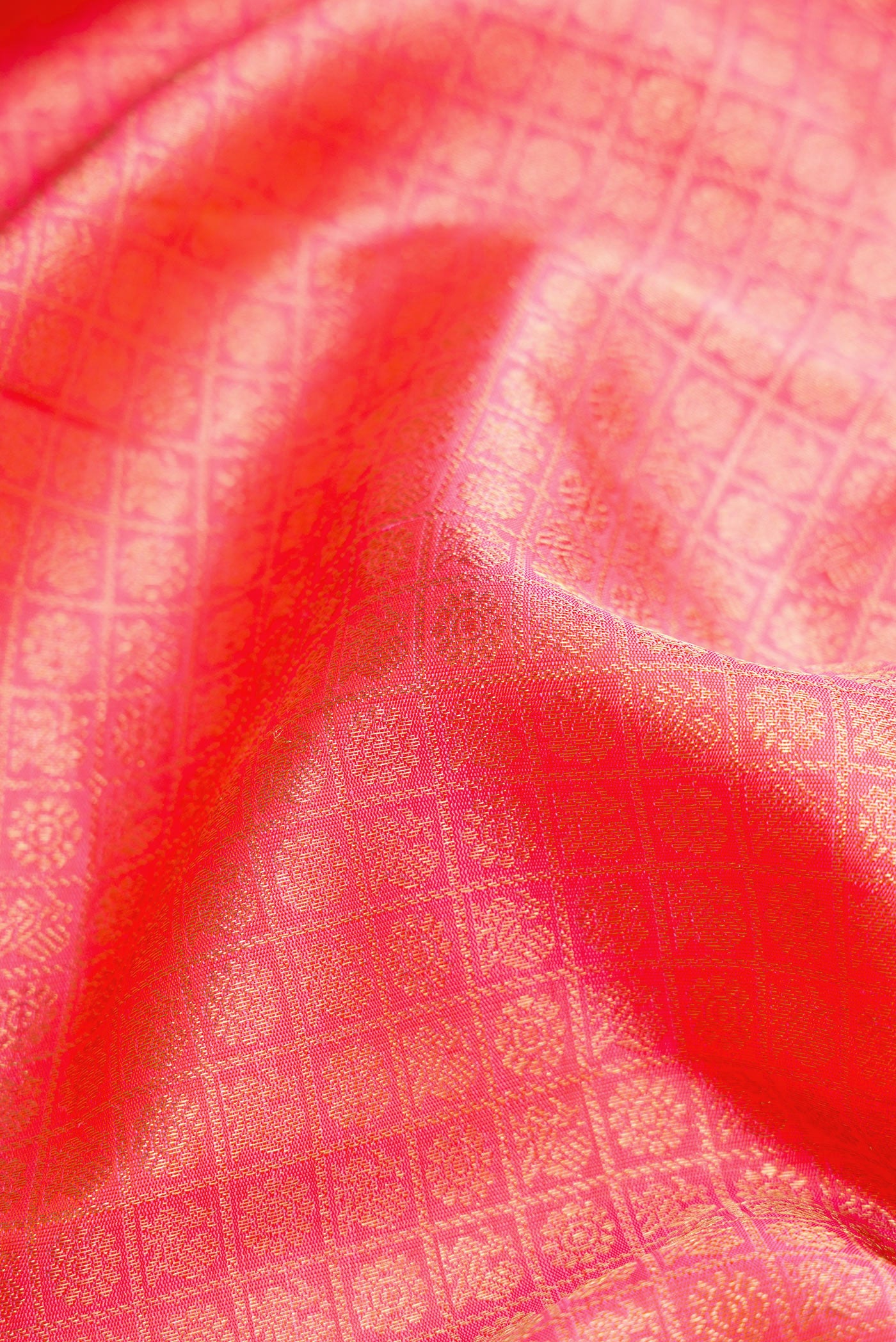 Close up of Pure Silk Pure Zari Pink Dual Tone Kanjivaram Saree with Zari Brocade on the body and Zari Border.  displaying folds